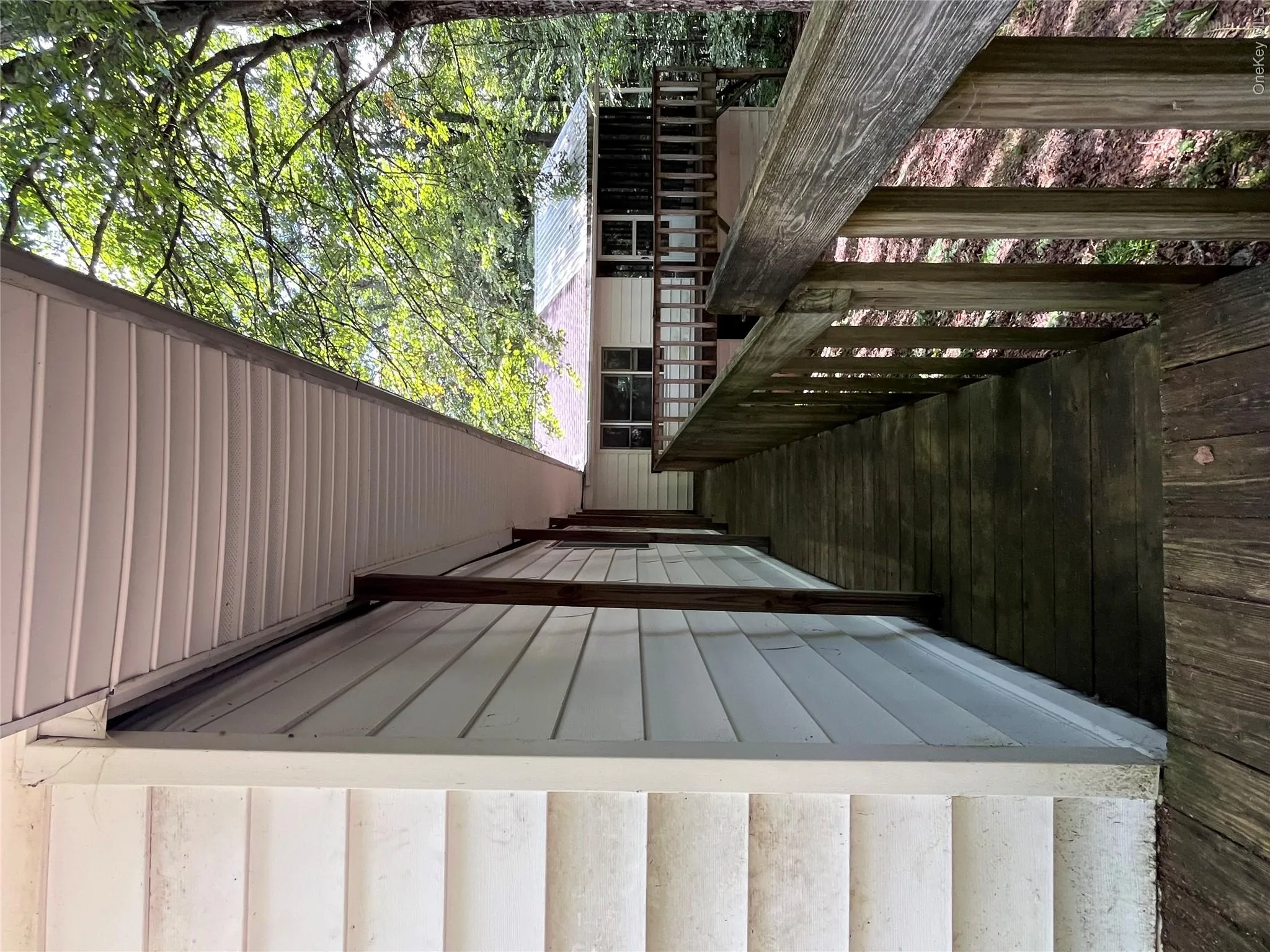 walkway around back of structure to access the screened in porch on the exterior walkway around back of structure to access the screened in porch on the exterior