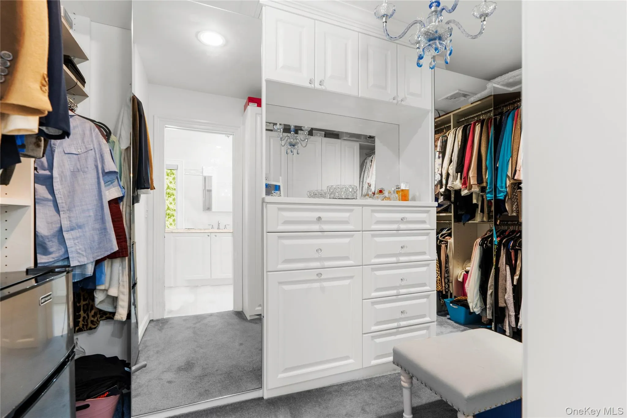 Spacious closet with light colored carpet Spacious closet with light colored carpet