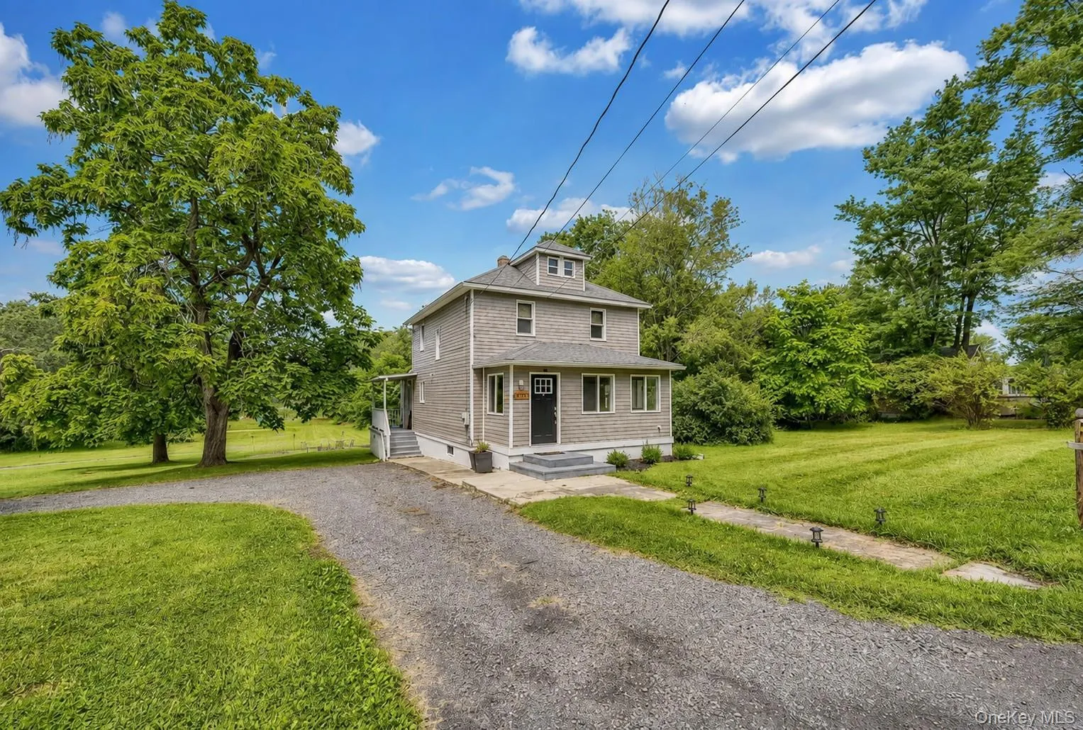 Two-story residence with gray siding and a dark entry door Two-story residence with gray siding and a dark entry door