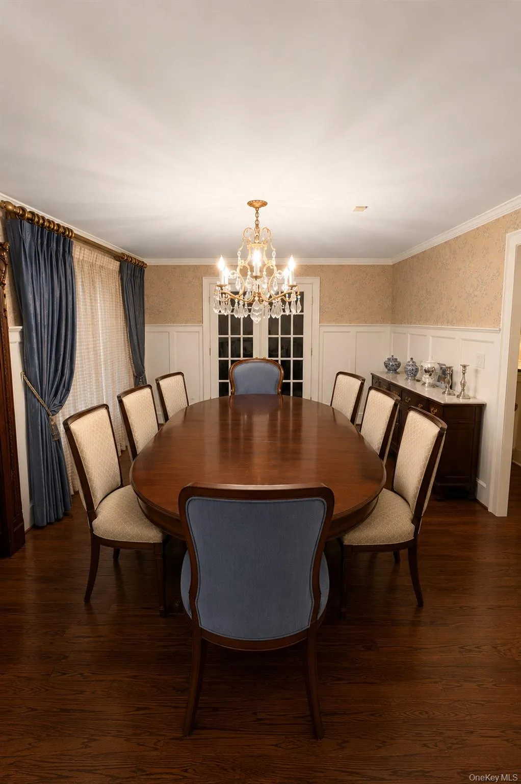Hardwood flooring, wainscoting, French doors, and an ornate chandelier Hardwood flooring, wainscoting, French doors, and an ornate chandelier