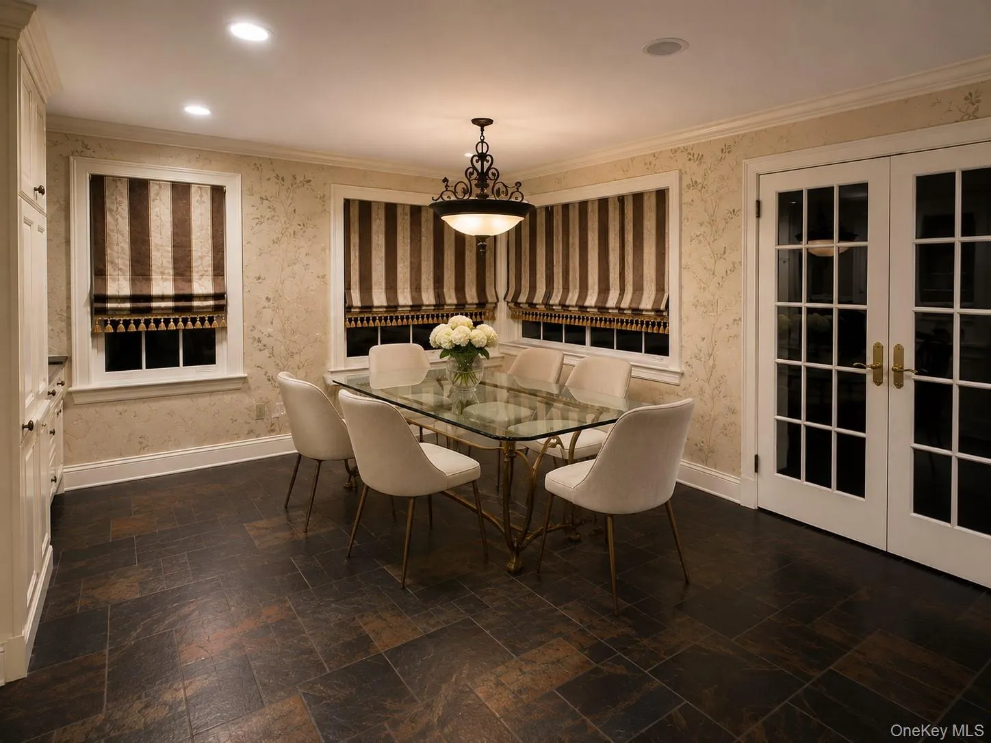 Recessed ceiling lighting, crown molding, double French doors, built-in cabinetry, and tile flooring Recessed ceiling lighting, crown molding, double French doors, built-in cabinetry, and tile flooring