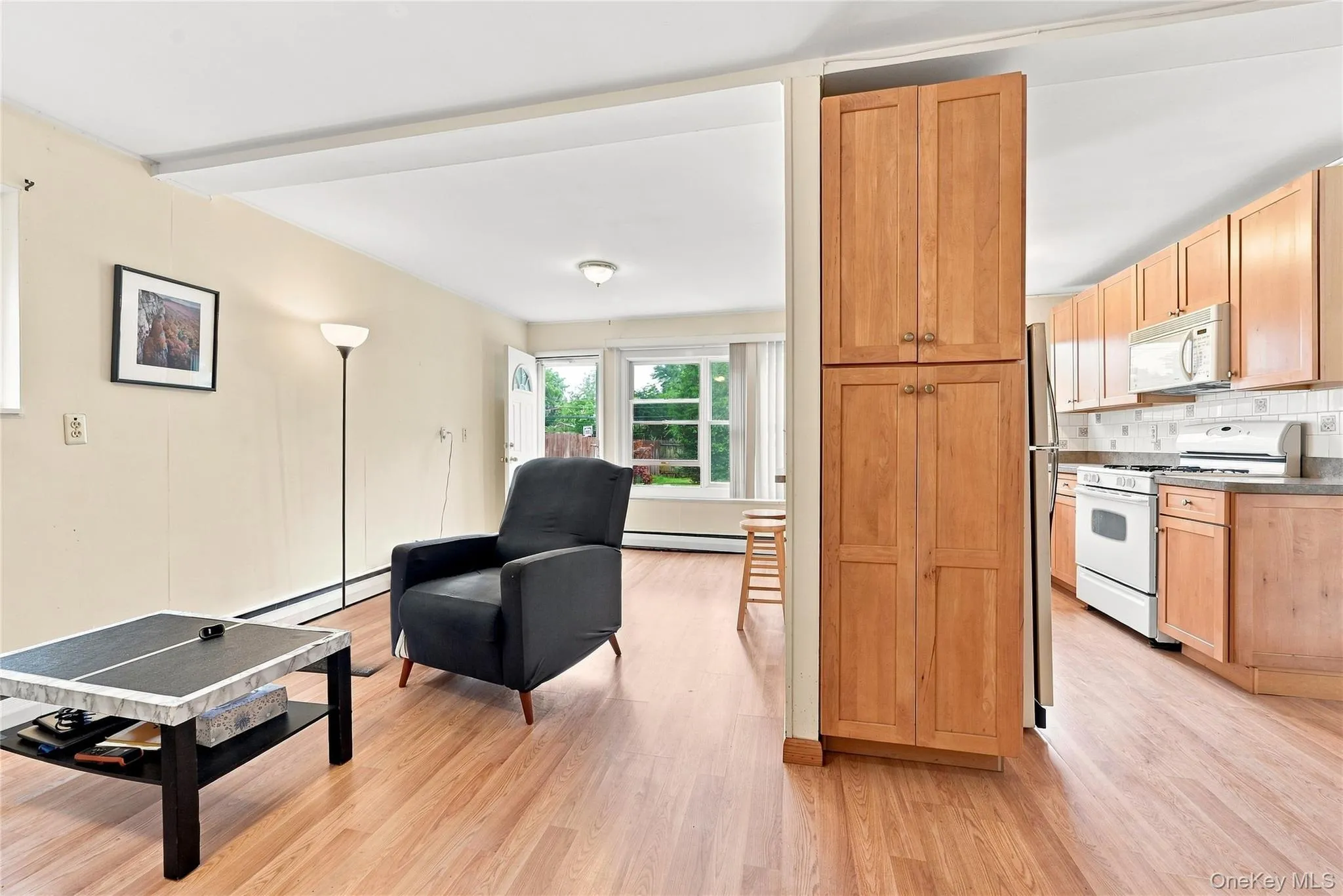 An abundance of Maple shaker cabinetry divides the Den from the working kitchen An abundance of Maple shaker cabinetry divides the Den from the working kitchen