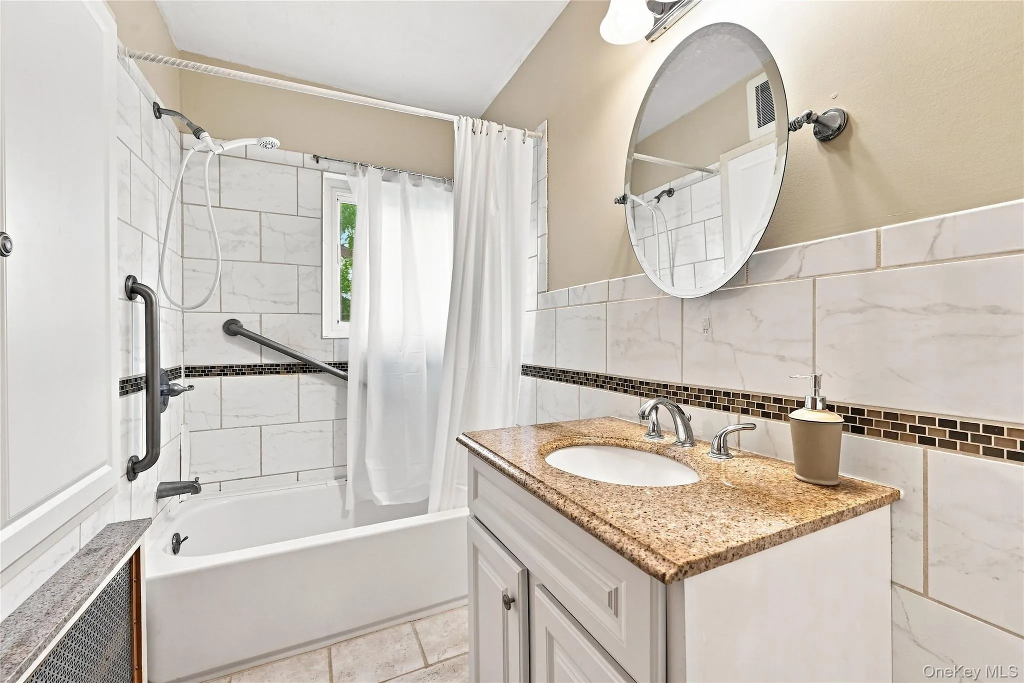 Full bathroom with tile surround, single sink vanity and interior storage cupboard Full bathroom with tile surround, single sink vanity and interior storage cupboard