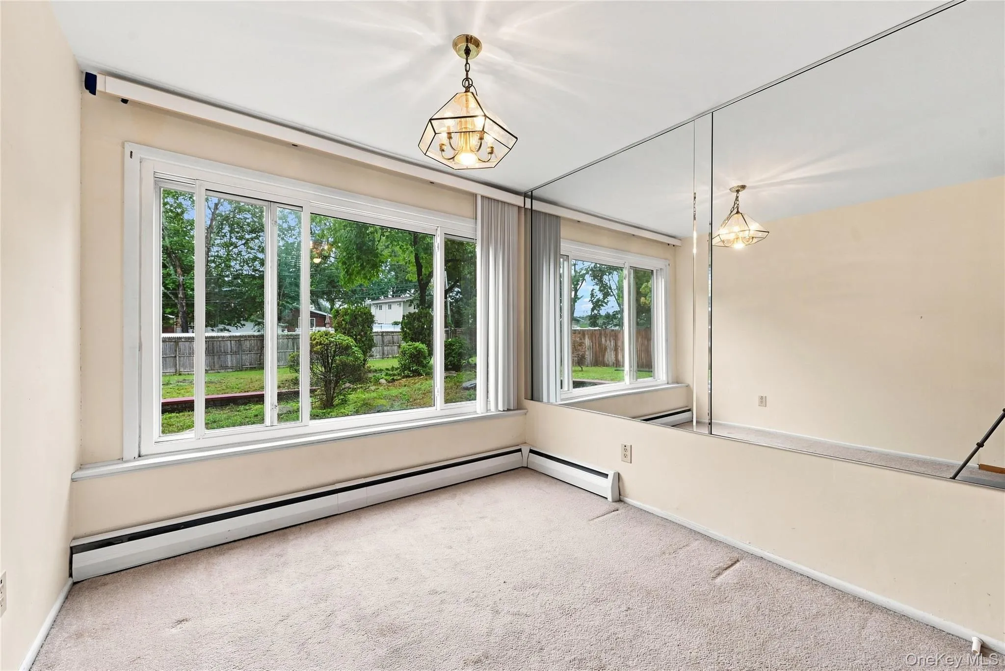 Full wall of windows to the yard - too distracting for an office? Perhaps a comfy chair for reading Full wall of windows to the yard - too distracting for an office? Perhaps a comfy chair for reading