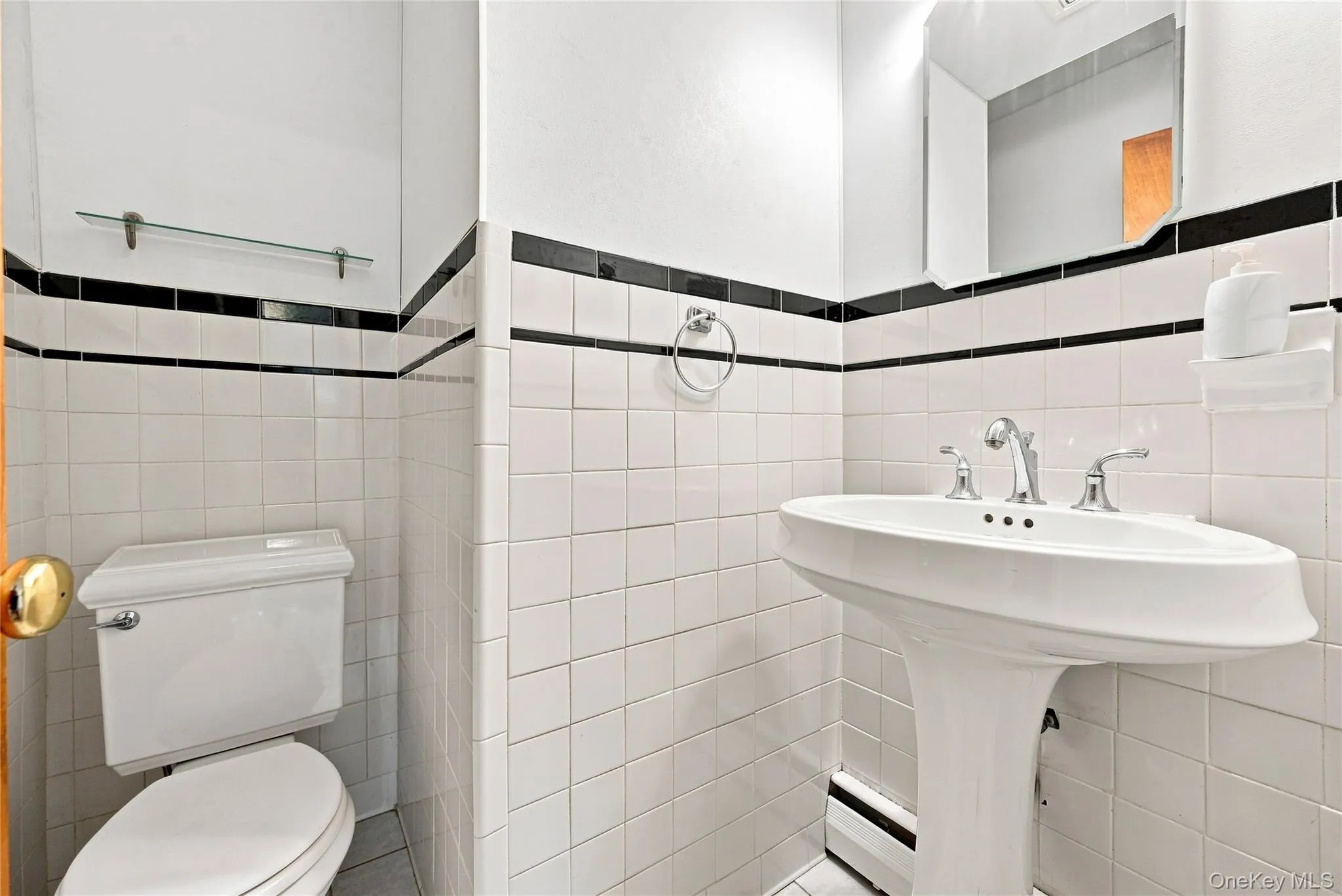 Lower level half bath with pedestal sink and tile surround Lower level half bath with pedestal sink and tile surround