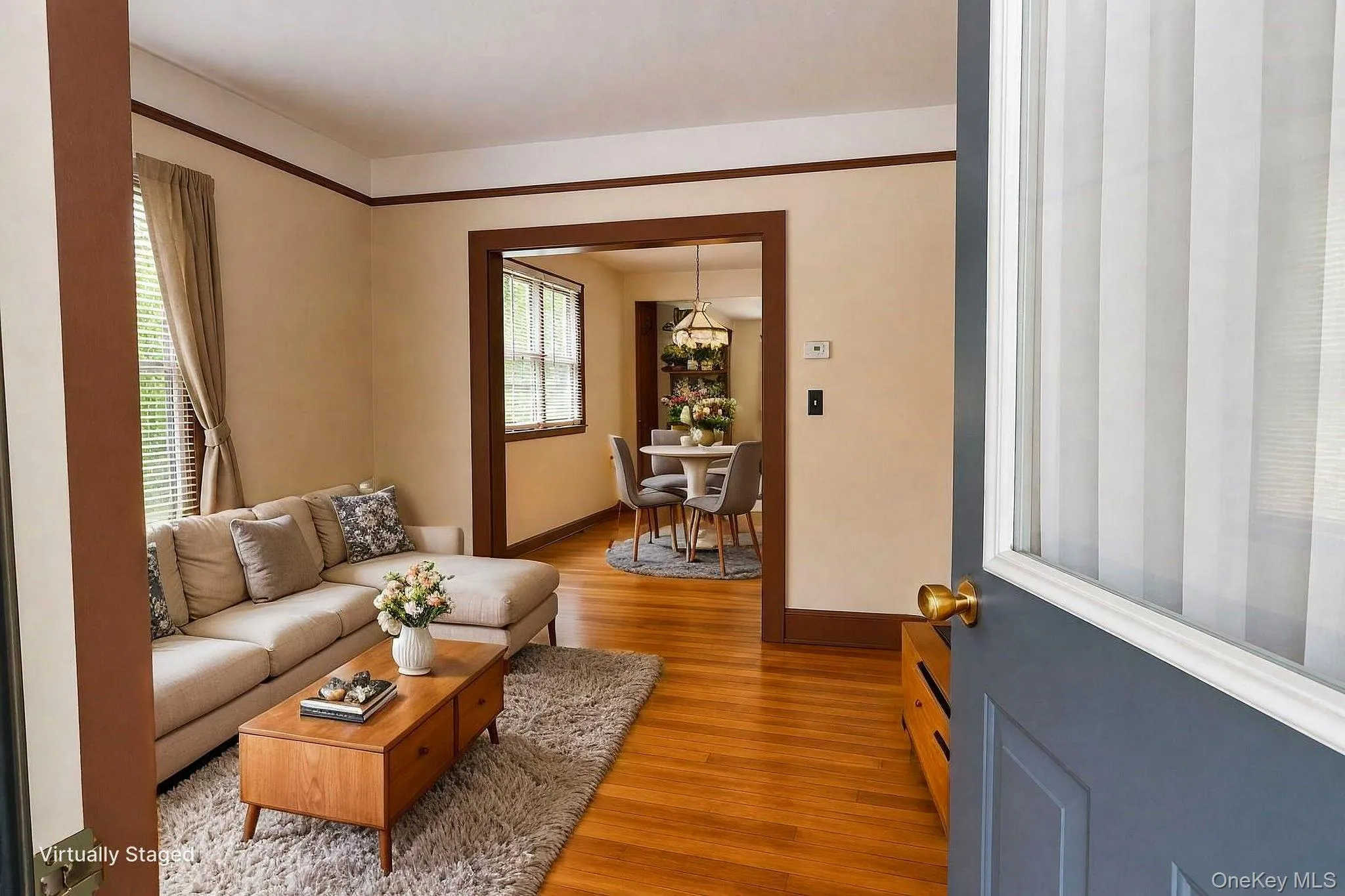 Hardwood flooring throughout the main living areas, featuring a spacious living area with a large window Hardwood flooring throughout the main living areas, featuring a spacious living area with a large window