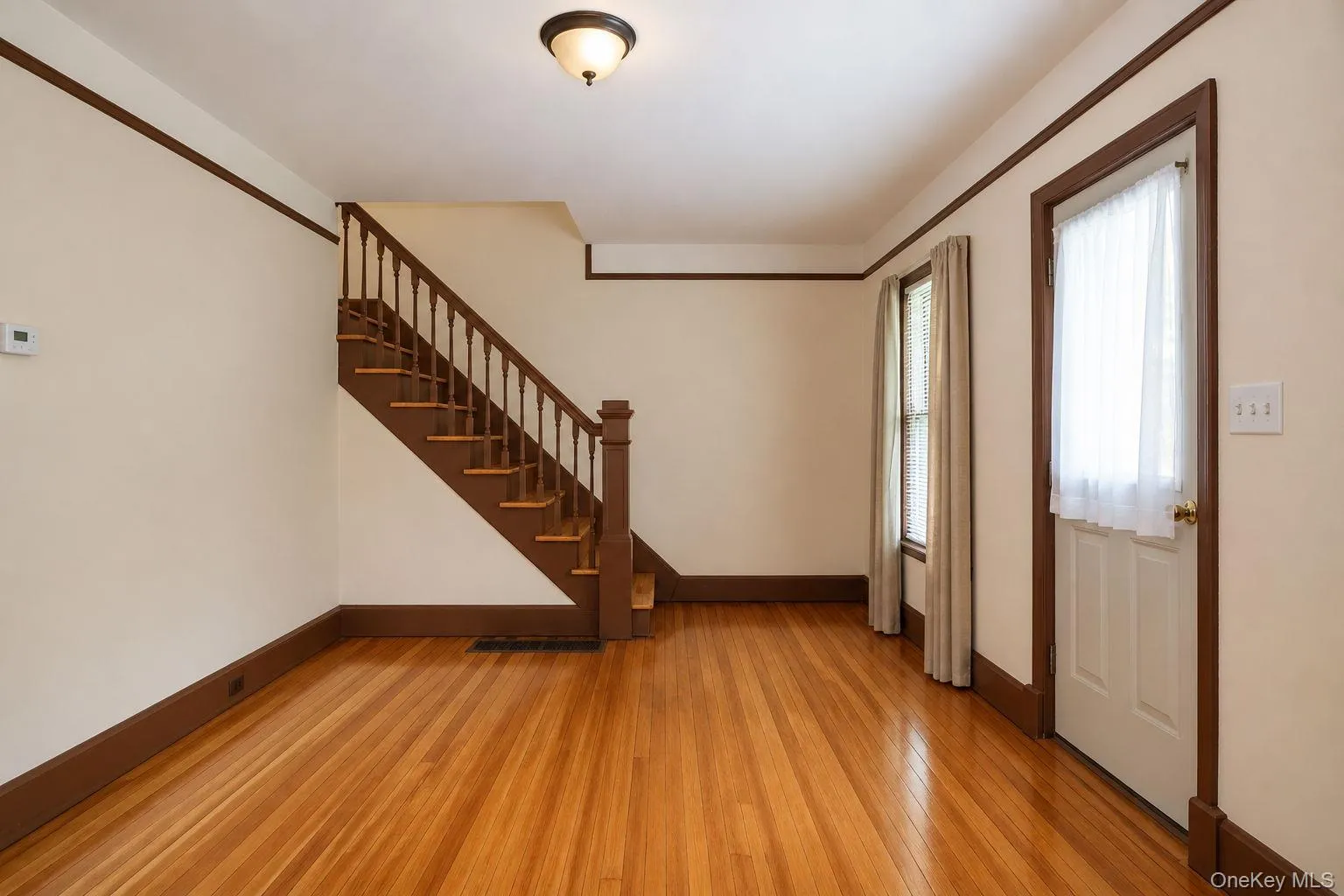 Warm wood-finish flooring complements the detailed wood trim and staircase Warm wood-finish flooring complements the detailed wood trim and staircase