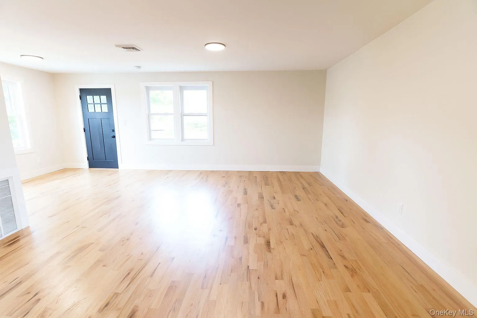 Spare room with light wood-type flooring and baseboards Spare room with light wood-type flooring and baseboards