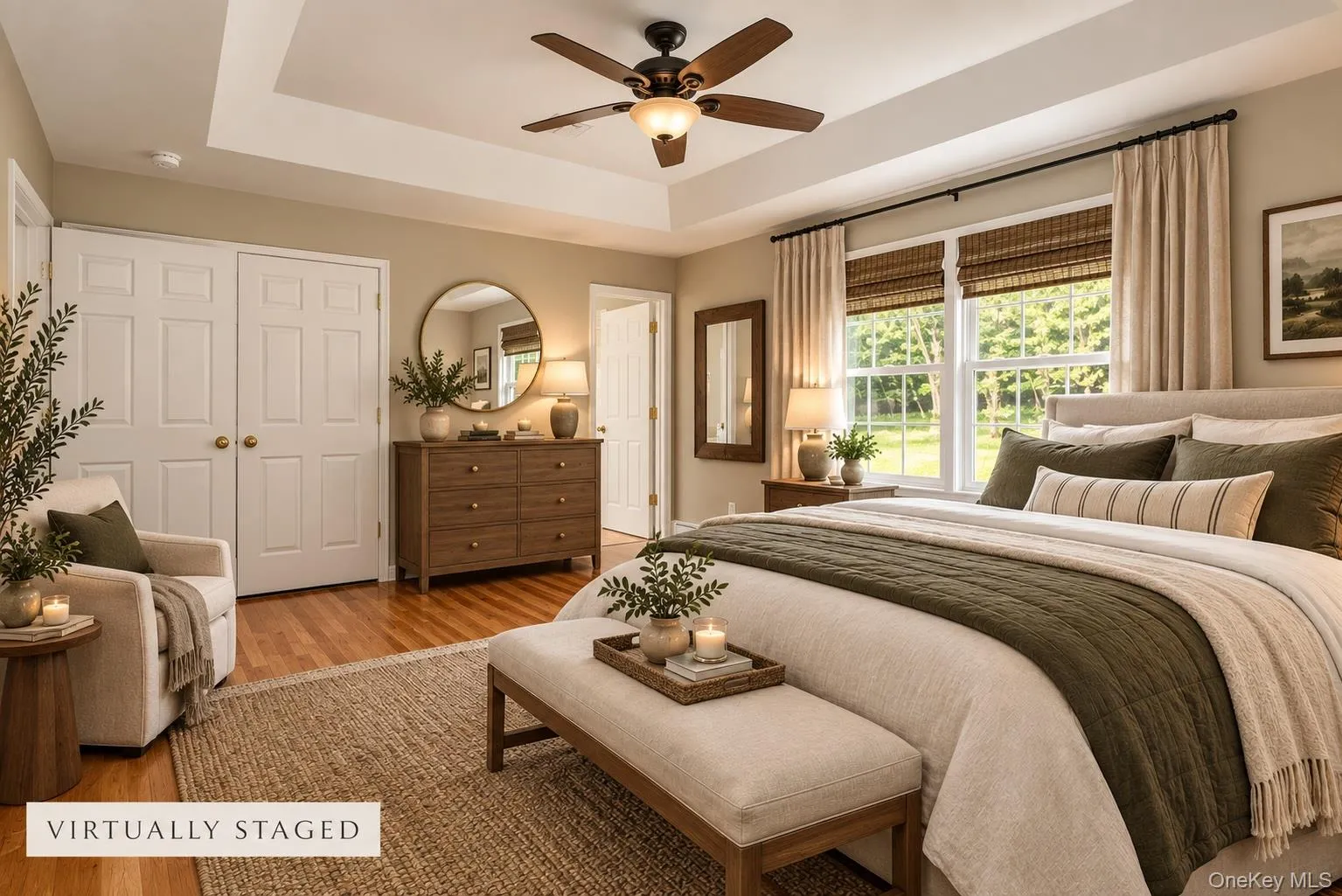 Tray ceiling with a ceiling fan, hardwood flooring, and a double-door closet Tray ceiling with a ceiling fan, hardwood flooring, and a double-door closet