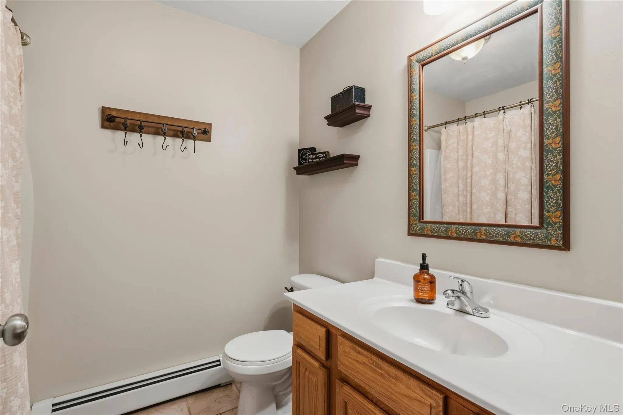 Vanity with integrated sink, chrome faucet, and wood-finish cabinetry Vanity with integrated sink, chrome faucet, and wood-finish cabinetry