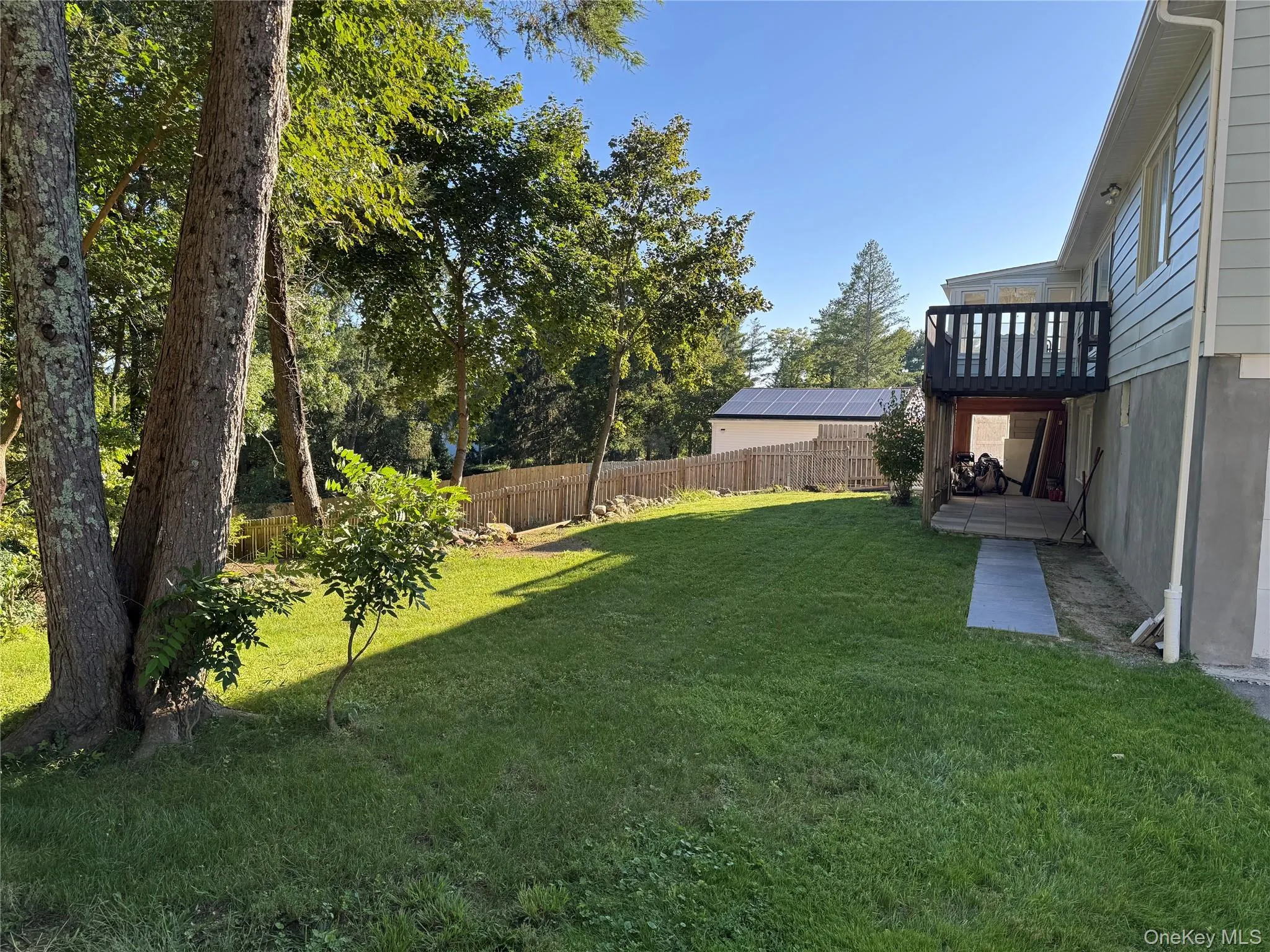 Back of house with deck and very spacious back yard, nearly one acre Back of house with deck and very spacious back yard, nearly one acre