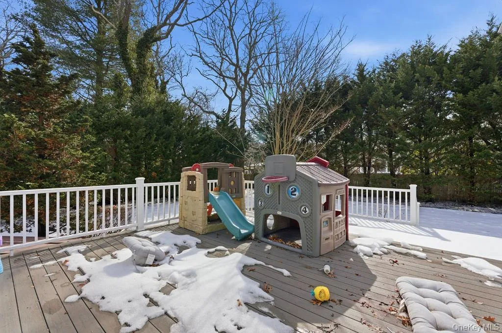 Spacious outdoor deck with protective railing, surrounded by mature trees Spacious outdoor deck with protective railing, surrounded by mature trees