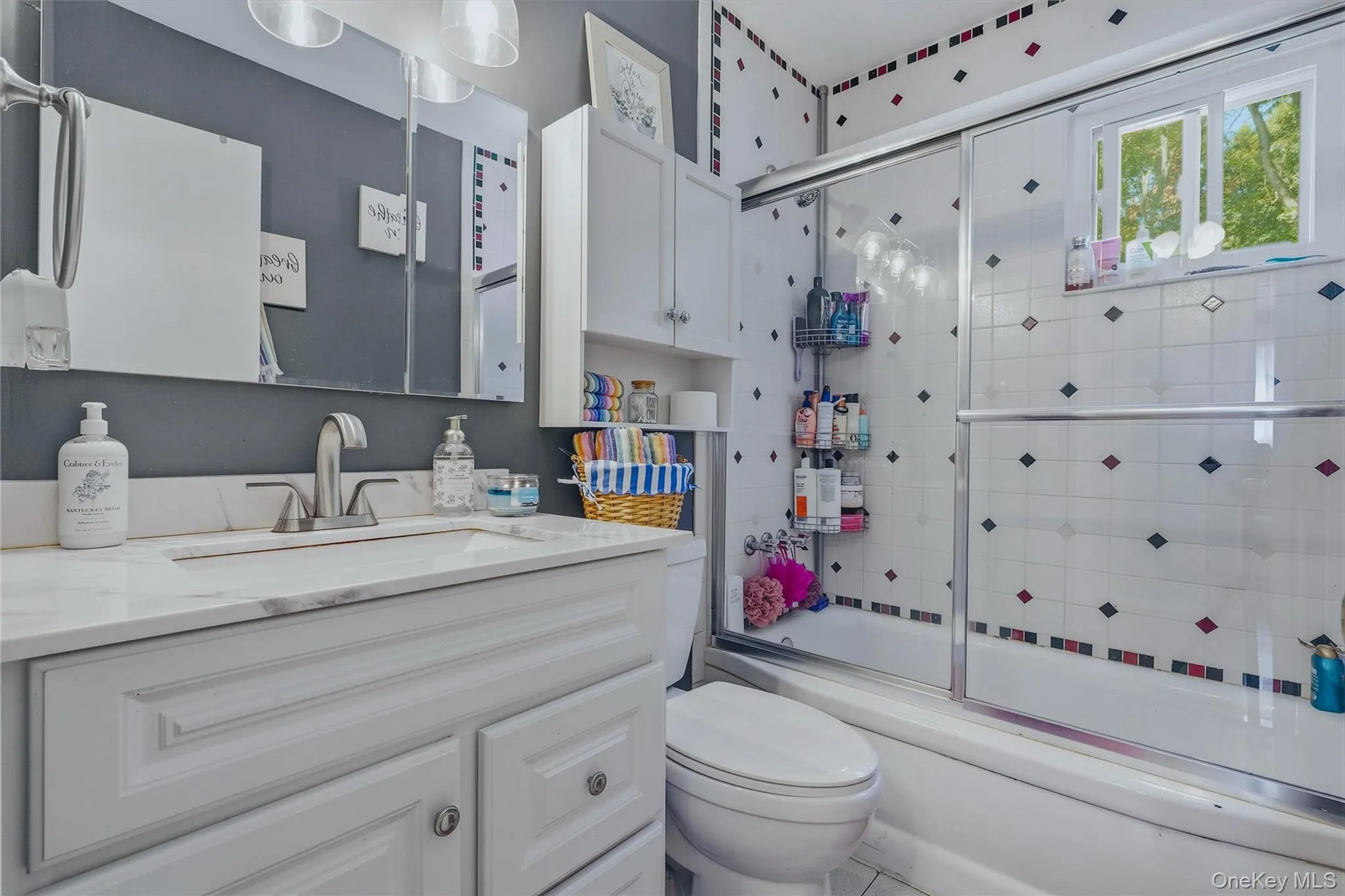 Bathroom with brushed nickel finishes, tiled shower with sliding glass door, and a window! Bathroom with brushed nickel finishes, tiled shower with sliding glass door, and a window!