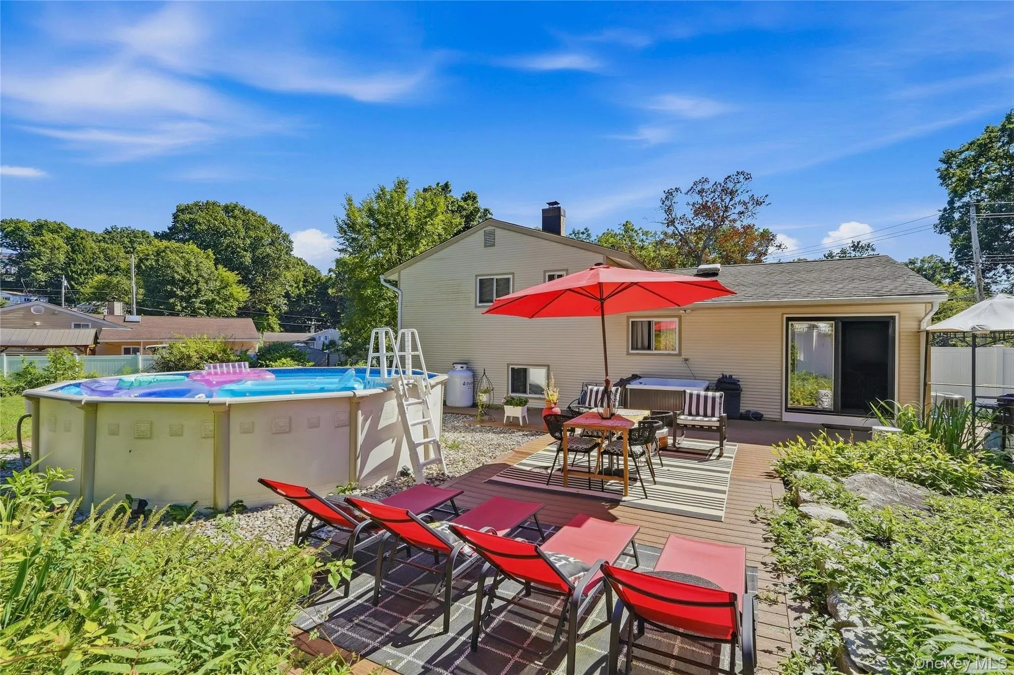Another view of the pool, another lounging area, outdoor dining area and hot tub. Another view of the pool, another lounging area, outdoor dining area and hot tub.