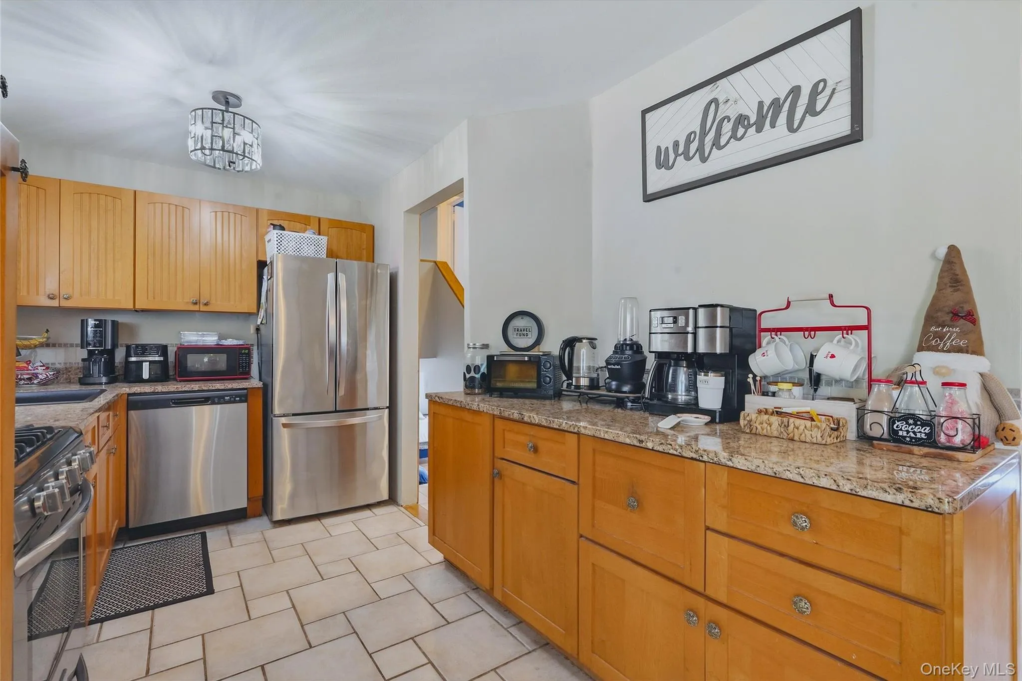 Maple-finish cabinetry, stainless, granite countertops, and tile flooring Maple-finish cabinetry, stainless, granite countertops, and tile flooring