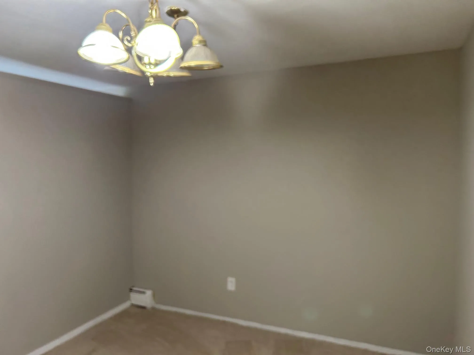 Spare room with carpet and a chandelier Spare room with carpet and a chandelier