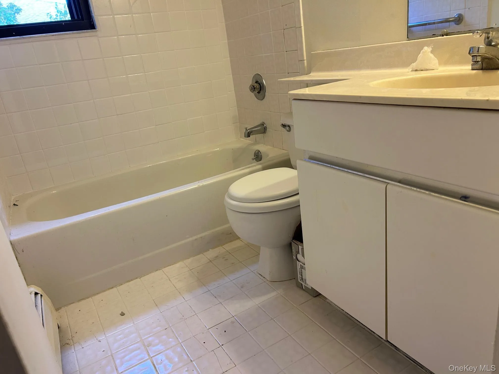 Full bath with vanity, shower combination, and light tile patterned floors Full bath with vanity, shower combination, and light tile patterned floors