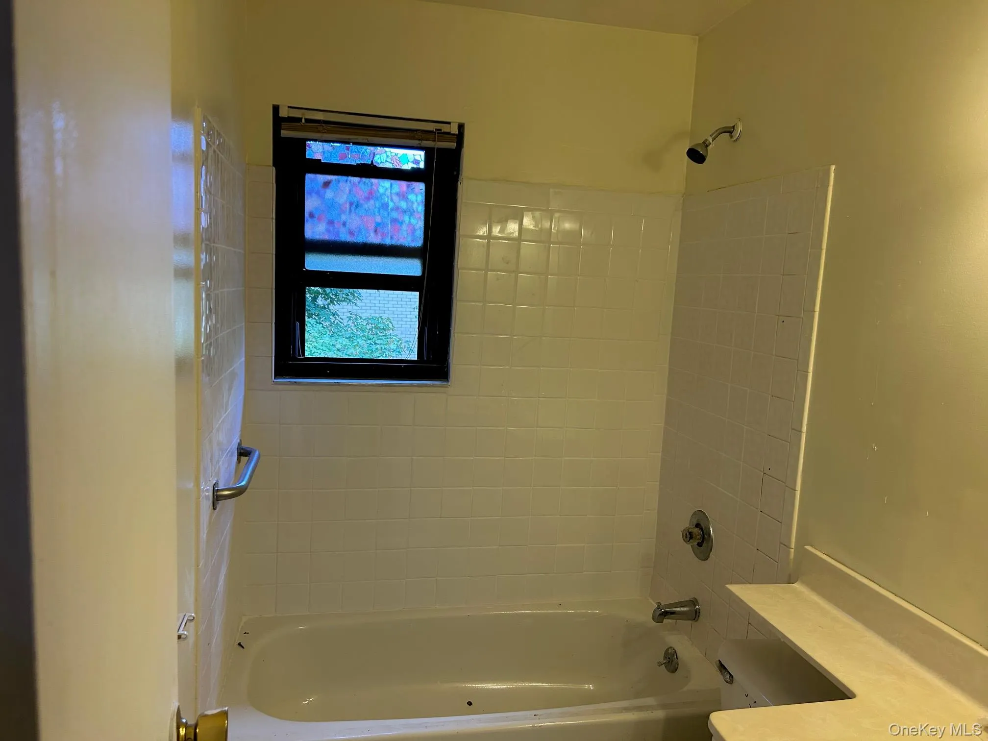Bathroom featuring tub / shower combination and vanity Bathroom featuring tub / shower combination and vanity