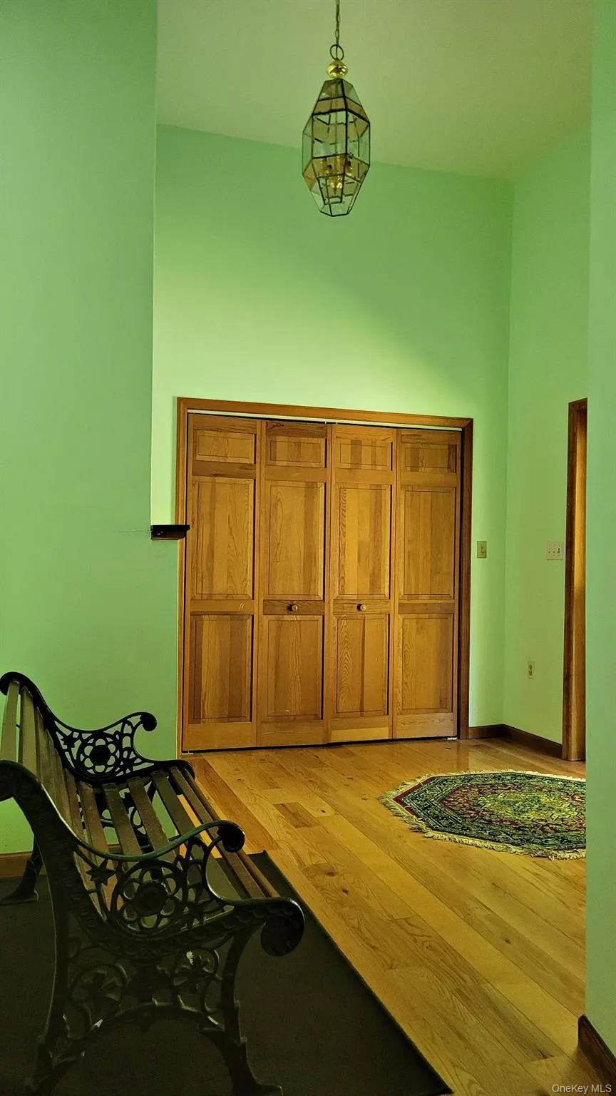 Large entryway with a cathedral ceiling, two closets, and an area for a bench. Large entryway with a cathedral ceiling, two closets, and an area for a bench.