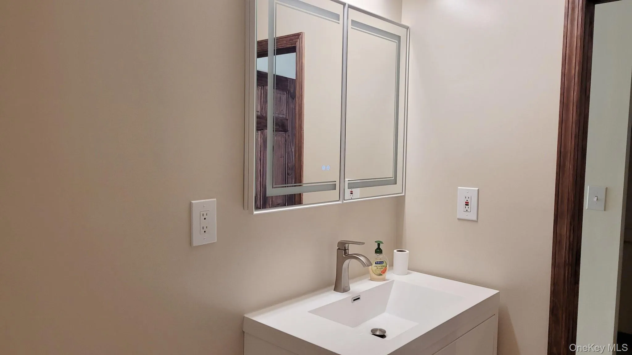 White vanity with integrated rectangular sink and brushed nickel faucet White vanity with integrated rectangular sink and brushed nickel faucet