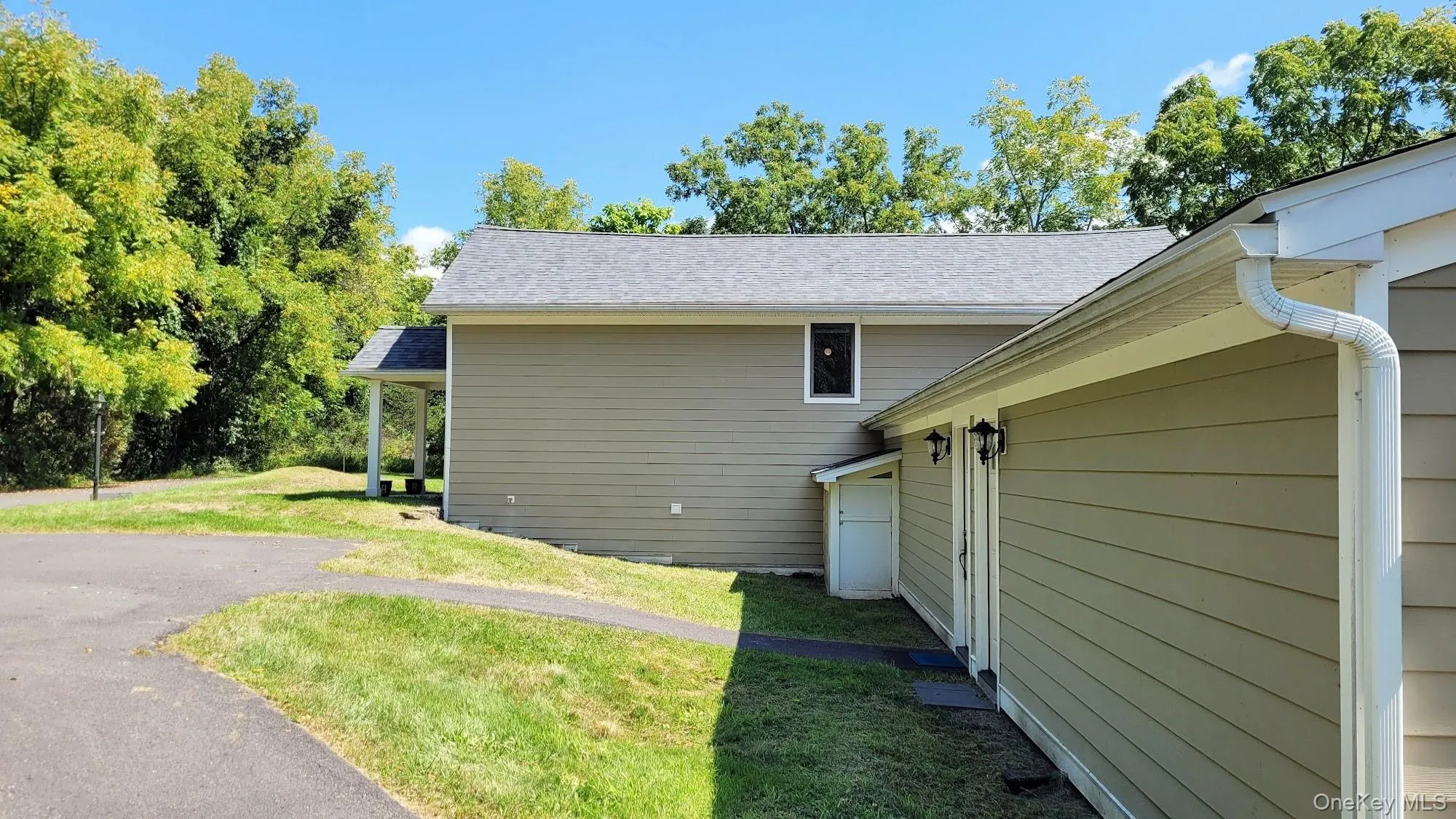 Siding exterior with a covered entry and attached secondary structure Siding exterior with a covered entry and attached secondary structure