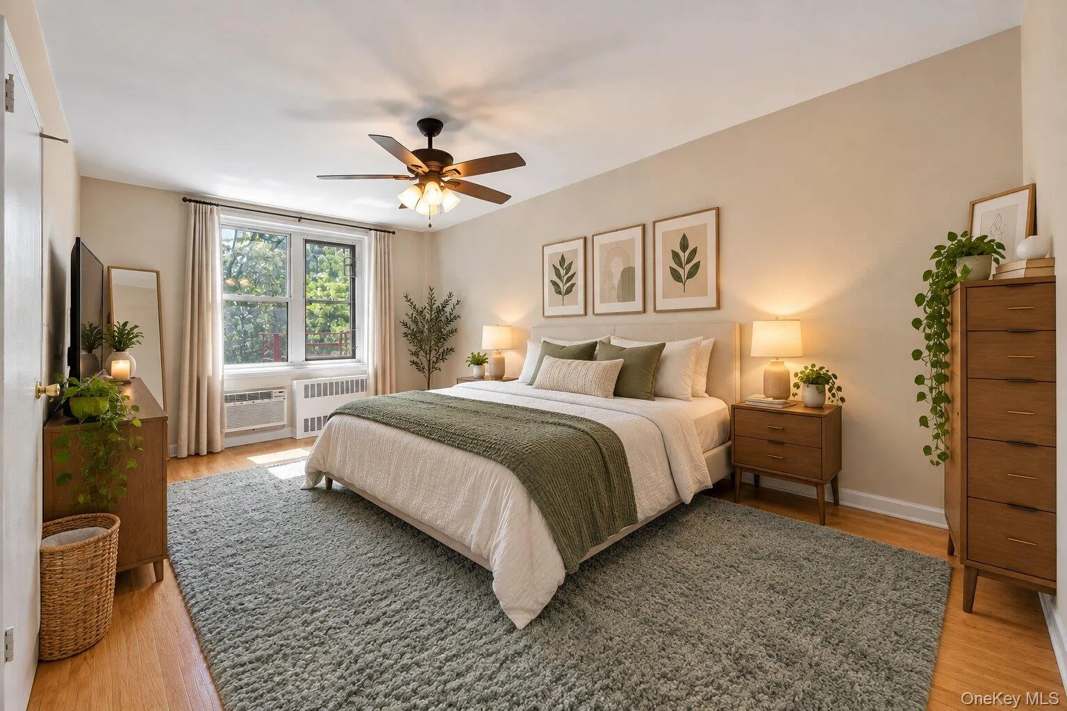Recessed window with substantial natural light, wood-finish flooring, ceiling fan with integrated lighting, built-in air conditioning unit, and neutral wall paint Recessed window with substantial natural light, wood-finish flooring, ceiling fan with integrated lighting, built-in air conditioning unit, and neutral wall paint