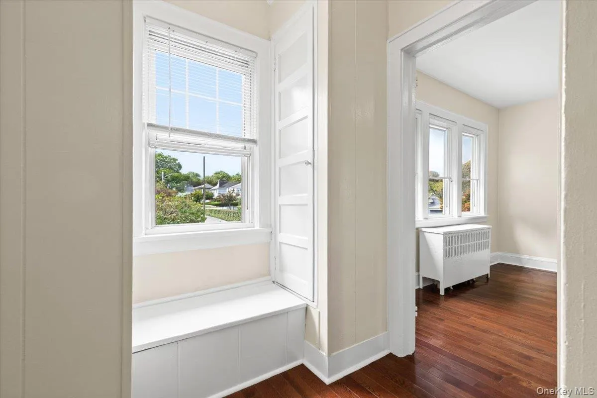 Hallway has two closets for long hanging items and a storage bench Hallway has two closets for long hanging items and a storage bench