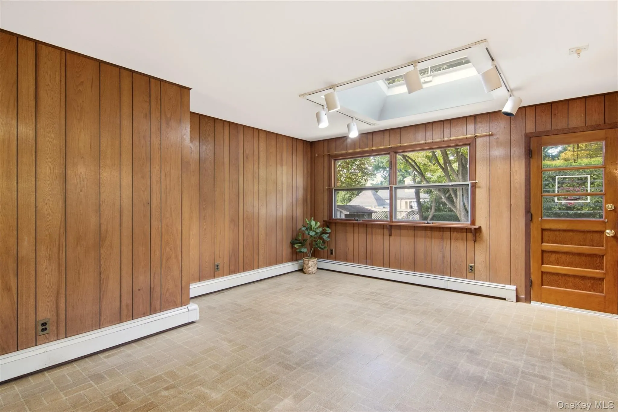 Dining area with skylight, Anderson picture window and door to backyard. Dining area with skylight, Anderson picture window and door to backyard.