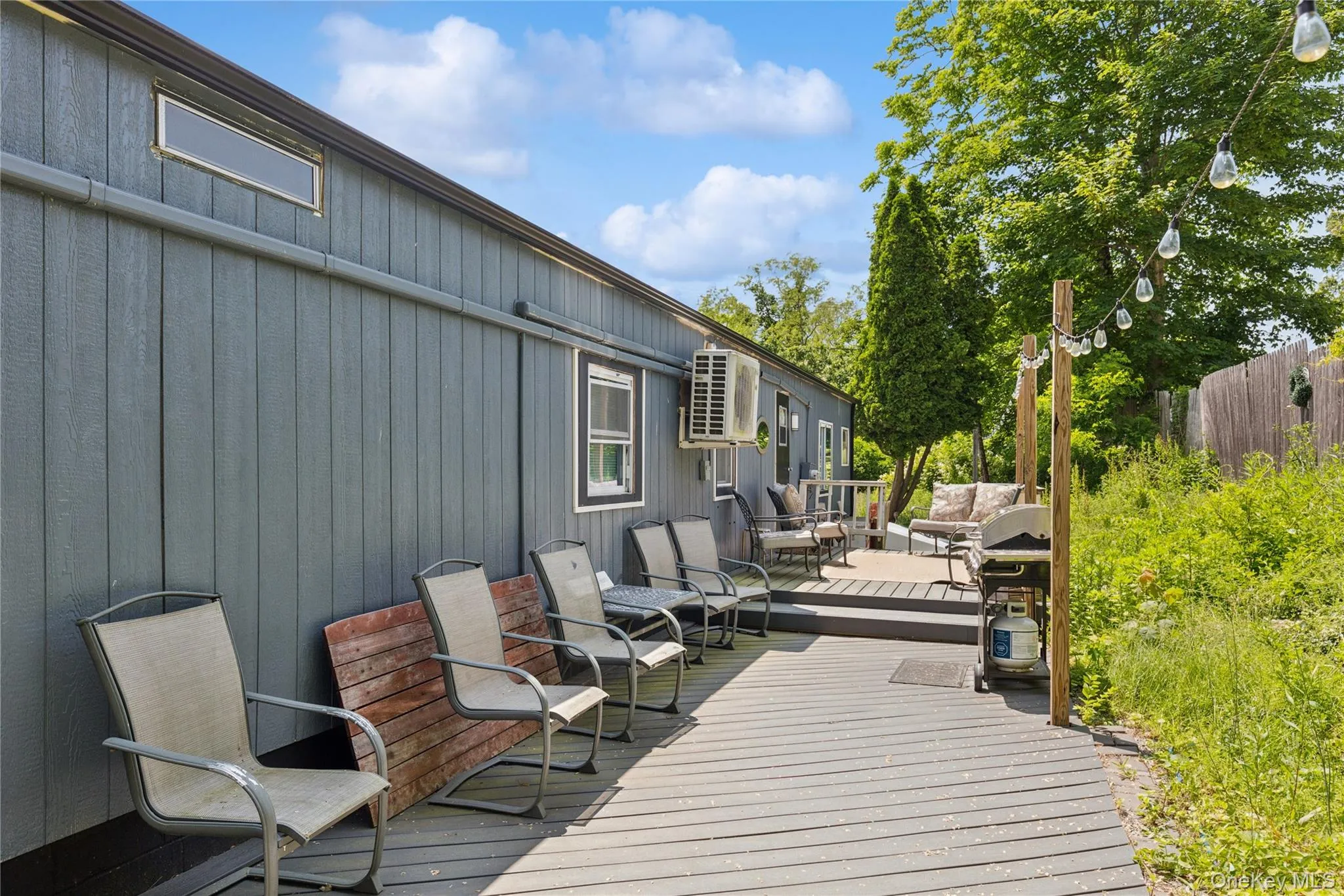 Wooden deck featuring an outdoor living space and a grill Wooden deck featuring an outdoor living space and a grill