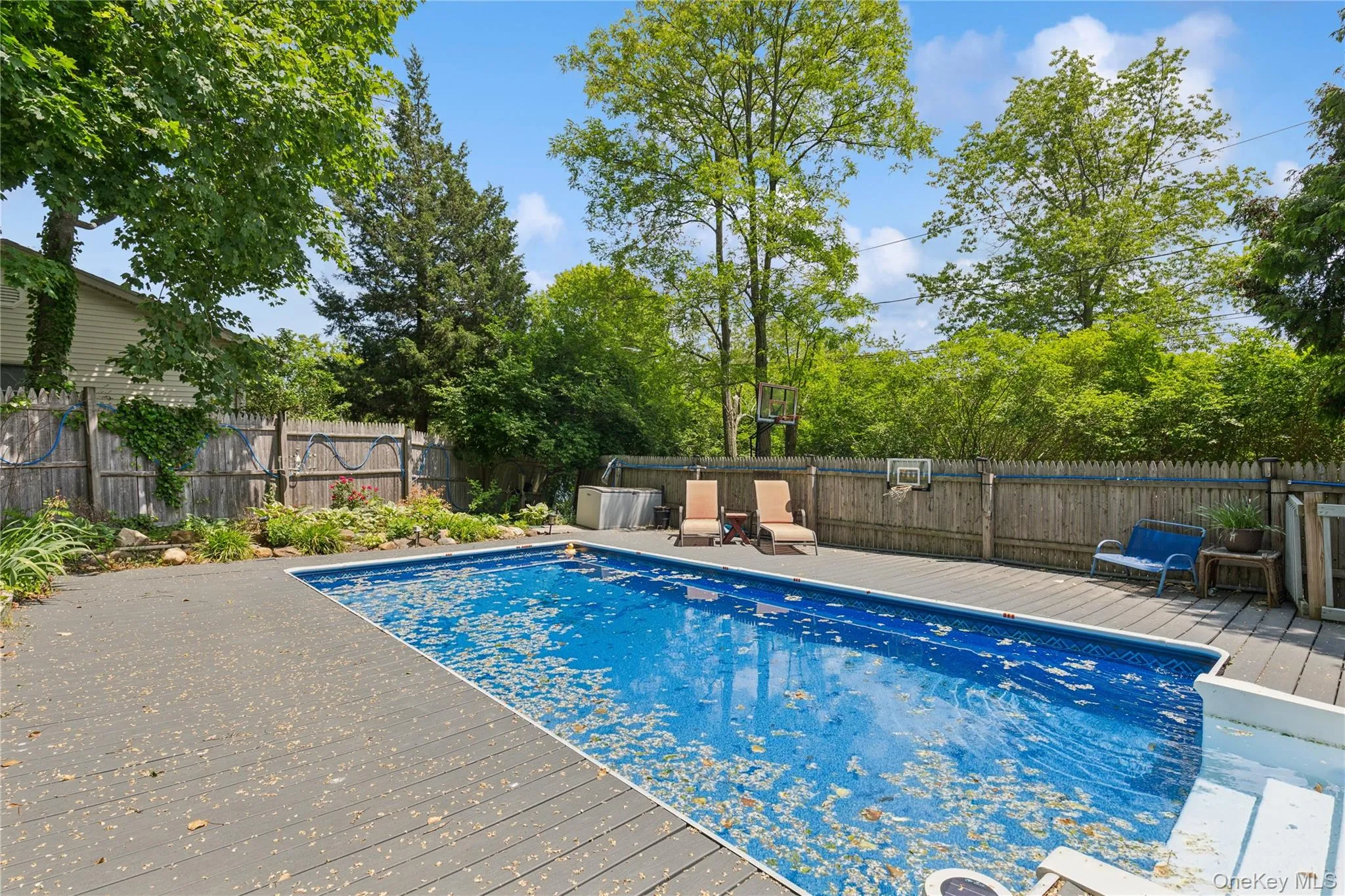 View of pool featuring a deck and a fenced backyard View of pool featuring a deck and a fenced backyard