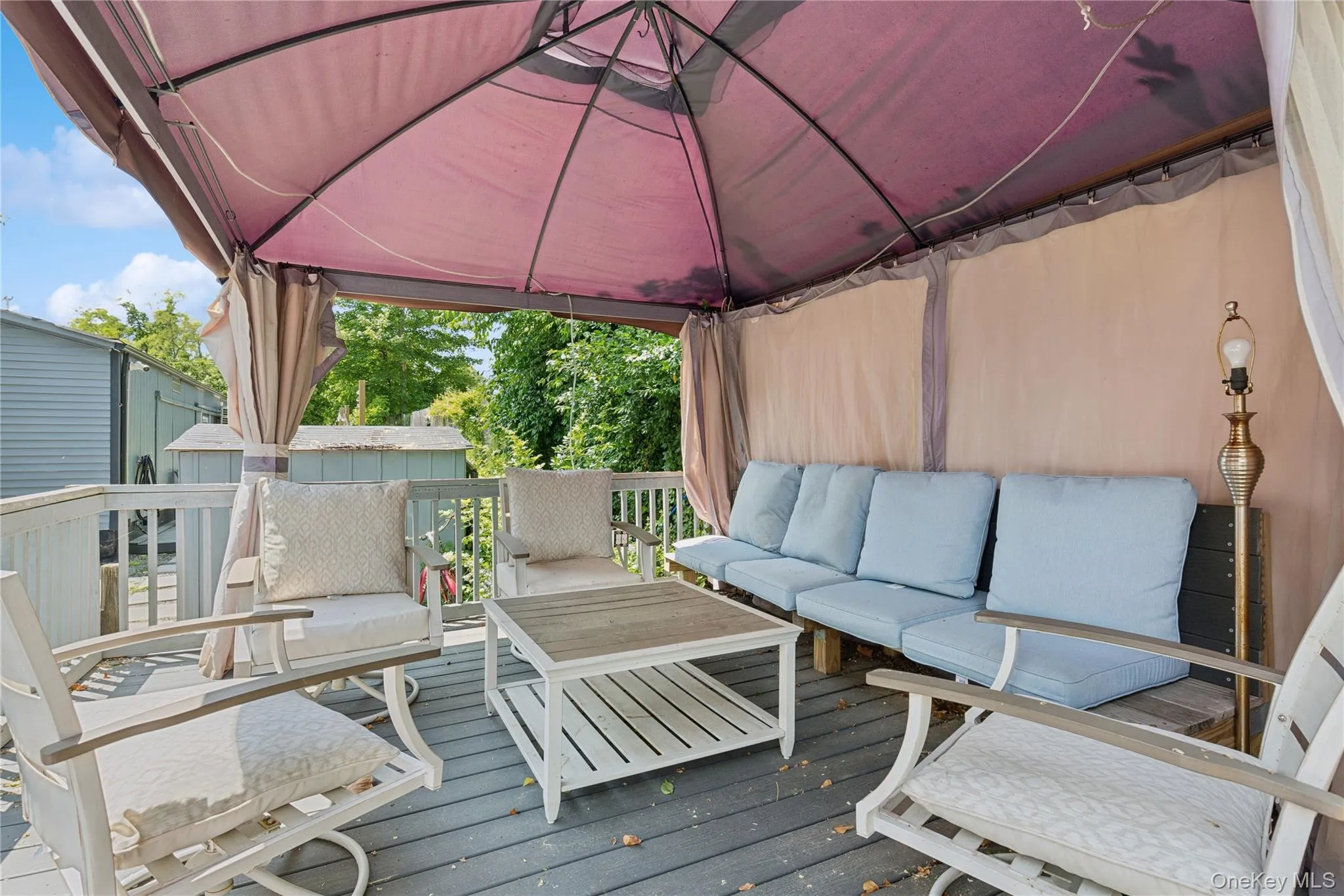 Wooden deck featuring an outdoor hangout area and a gazebo Wooden deck featuring an outdoor hangout area and a gazebo