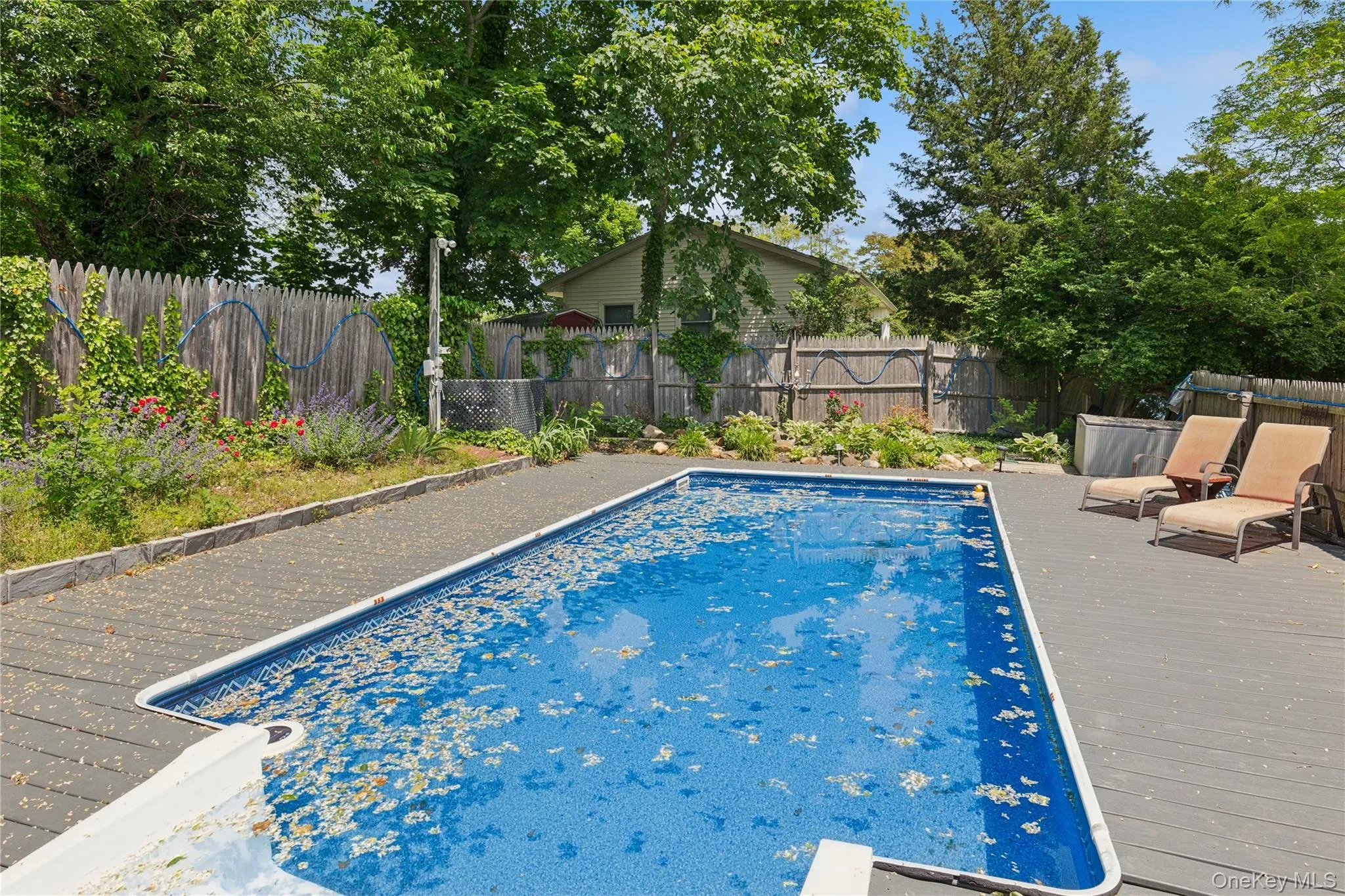 View of pool with a fenced backyard and a wooden deck View of pool with a fenced backyard and a wooden deck