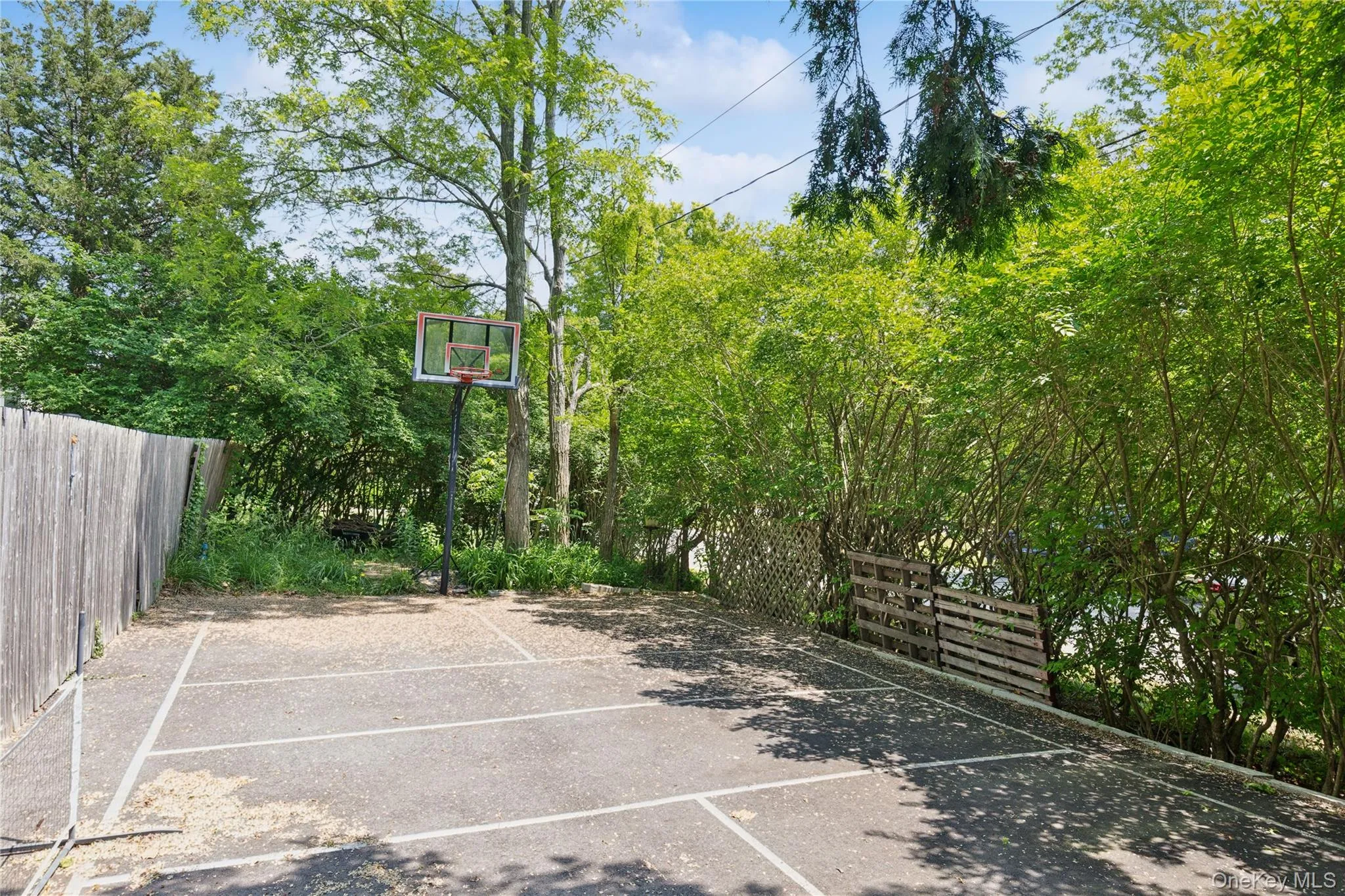 View of sport court featuring basketball hoop View of sport court featuring basketball hoop