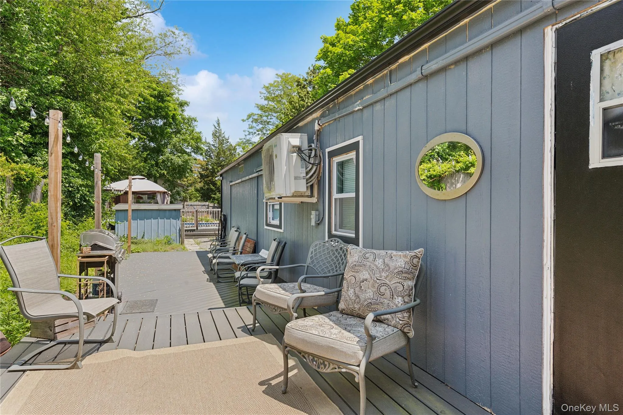 Wooden terrace with area for grilling and view of wooded area Wooden terrace with area for grilling and view of wooded area