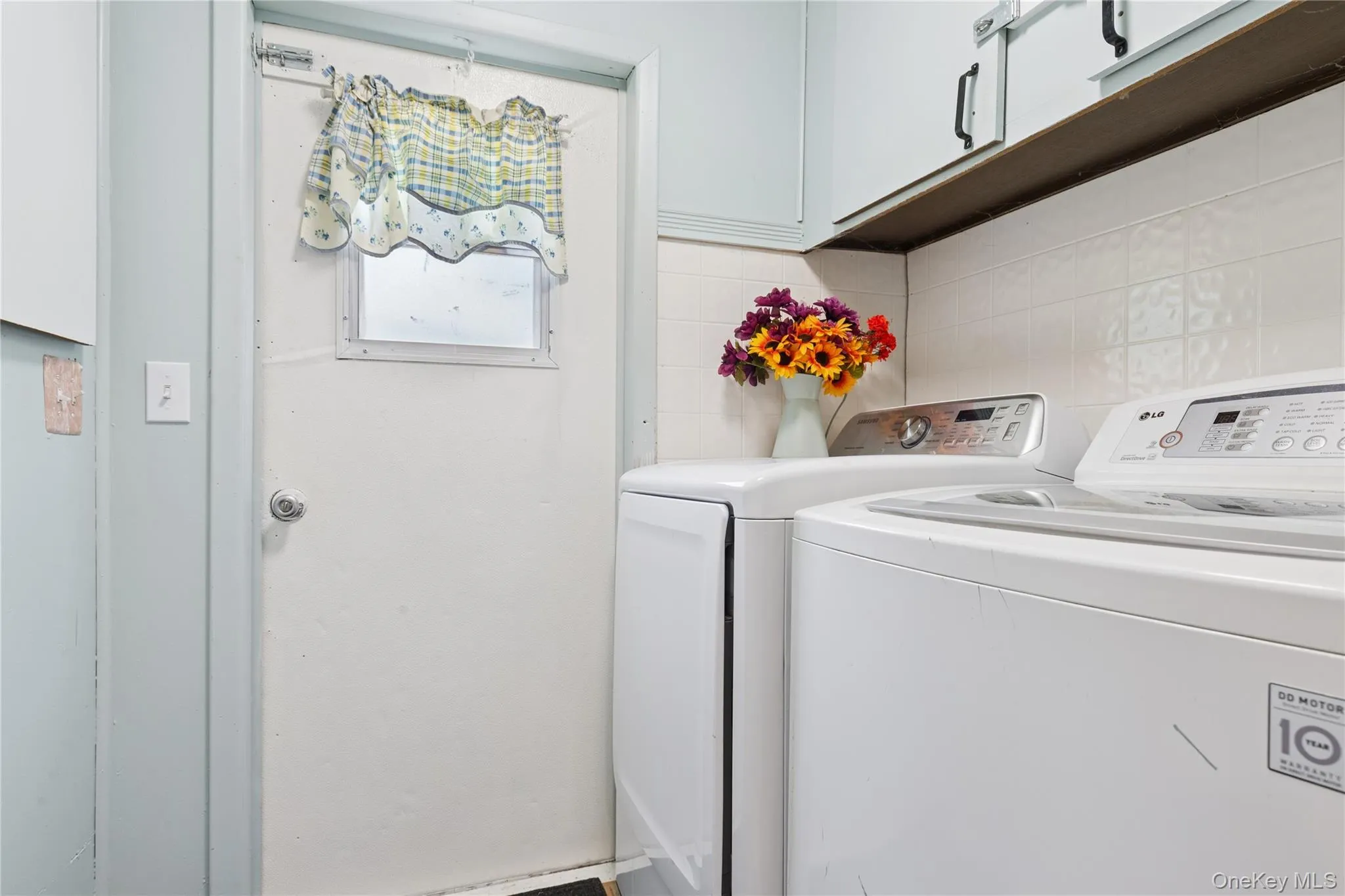 Laundry room featuring separate washer and dryer and cabinet space Laundry room featuring separate washer and dryer and cabinet space