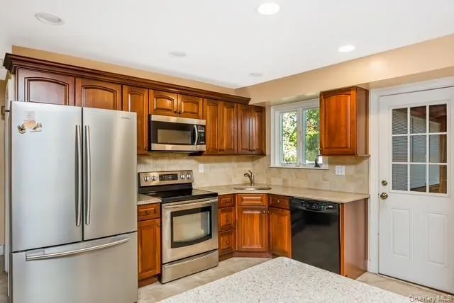 The kitchen has plenty of cabinets and counter space, stainless steel appliances with a back door to a “Florida room “. The kitchen has plenty of cabinets and counter space, stainless steel appliances with a back door to a “Florida room “.