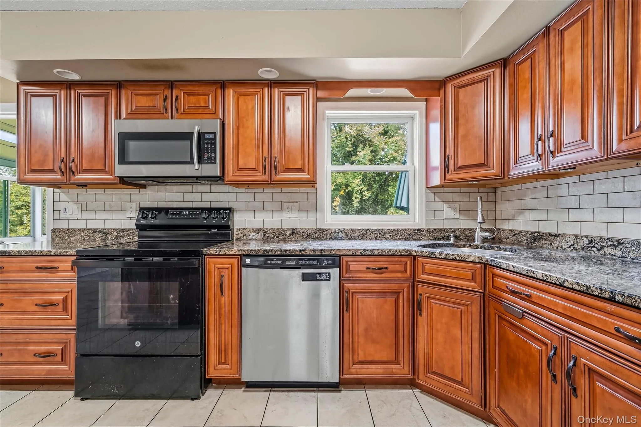 Detailed view of the cabinetry, countertops, and kitchen appliances. Detailed view of the cabinetry, countertops, and kitchen appliances.