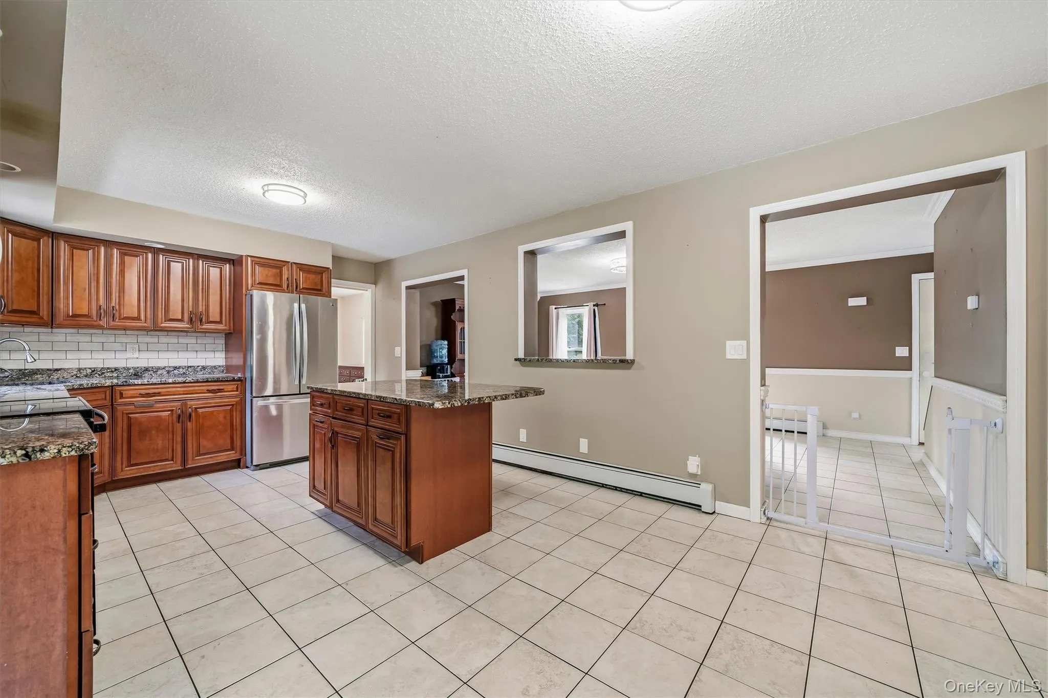 Open view from the kitchen toward the adjoining dining and living areas. Open view from the kitchen toward the adjoining dining and living areas.