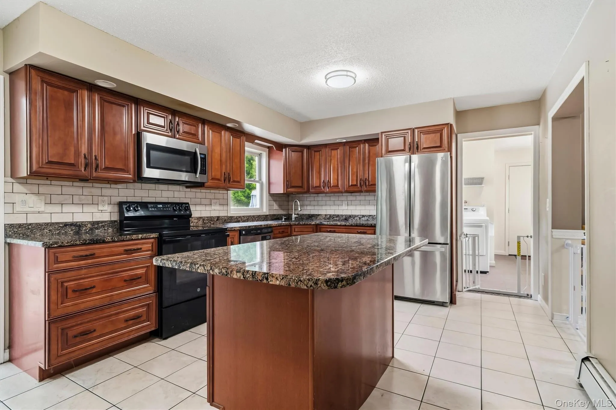 Granite center island provides additional counter space and storage. Granite center island provides additional counter space and storage.