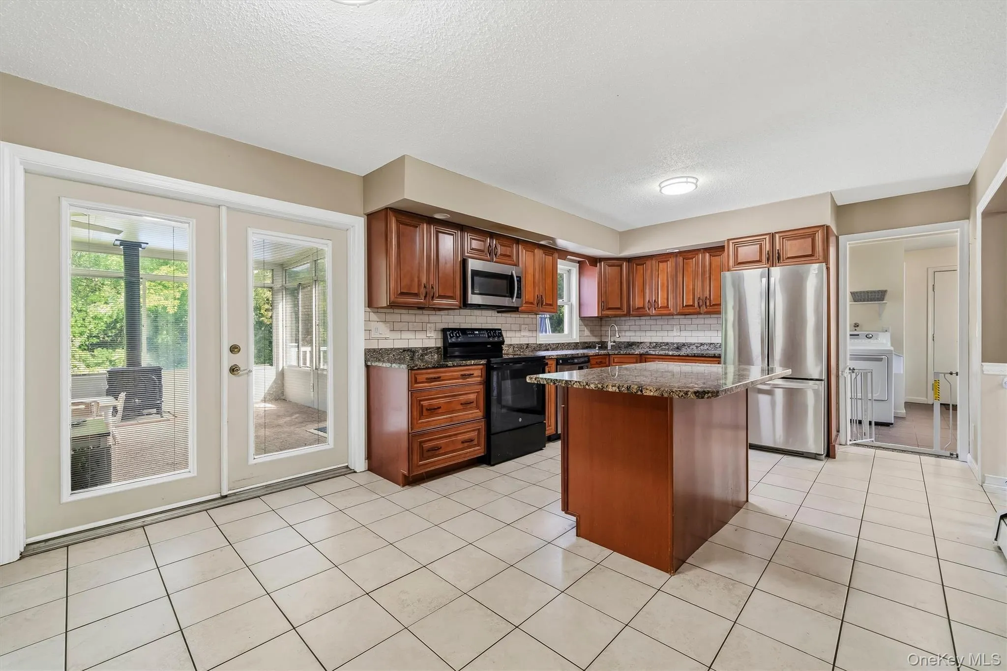 Spacious kitchen with granite countertops, center island, ample cabinetry, and stainless steel appliances. Spacious kitchen with granite countertops, center island, ample cabinetry, and stainless steel appliances.