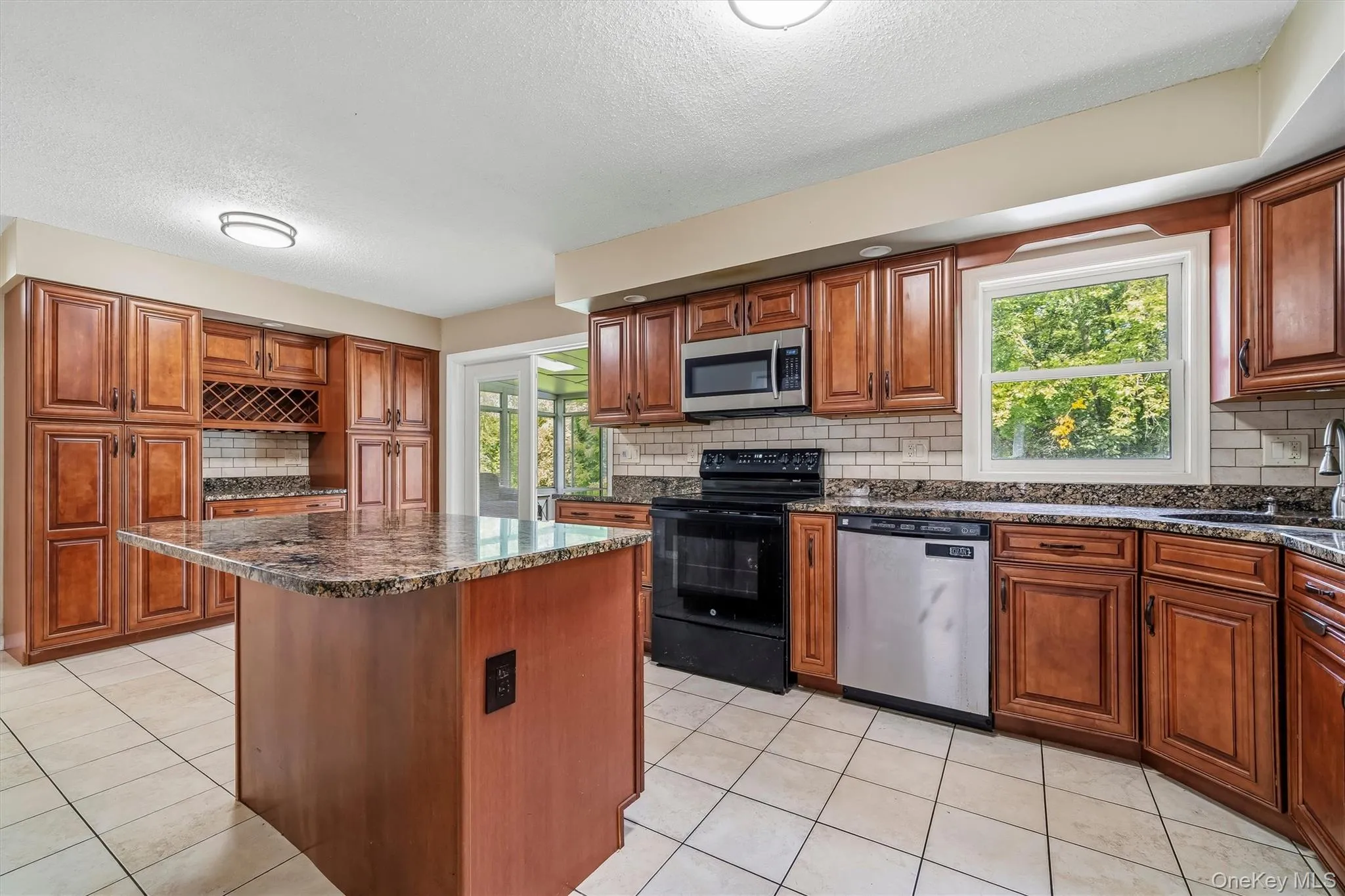 Kitchen features abundant cabinetry, granite countertops, and stainless steel appliances. Kitchen features abundant cabinetry, granite countertops, and stainless steel appliances.