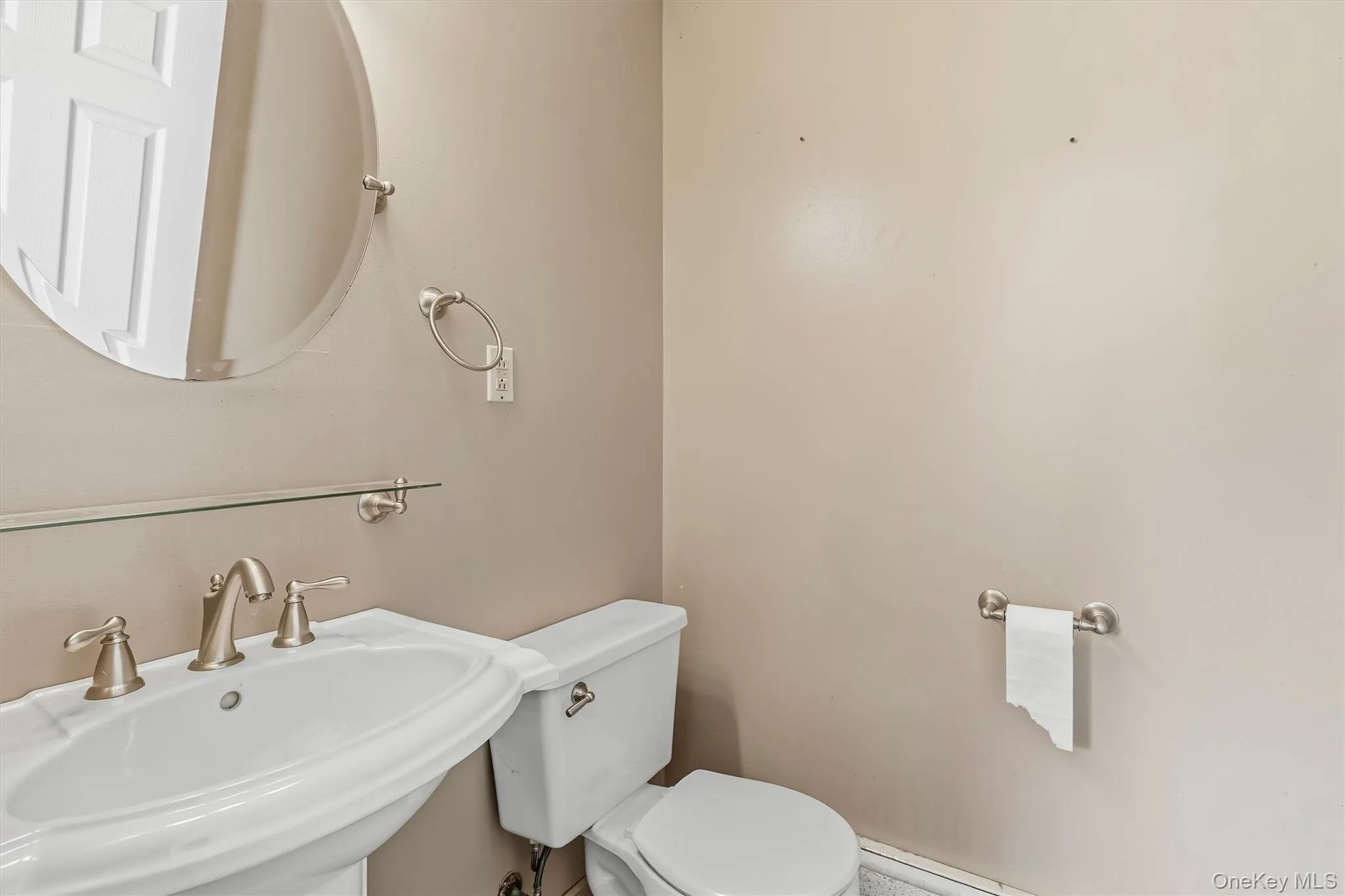 Main-level half bath with pedestal sink. Main-level half bath with pedestal sink.