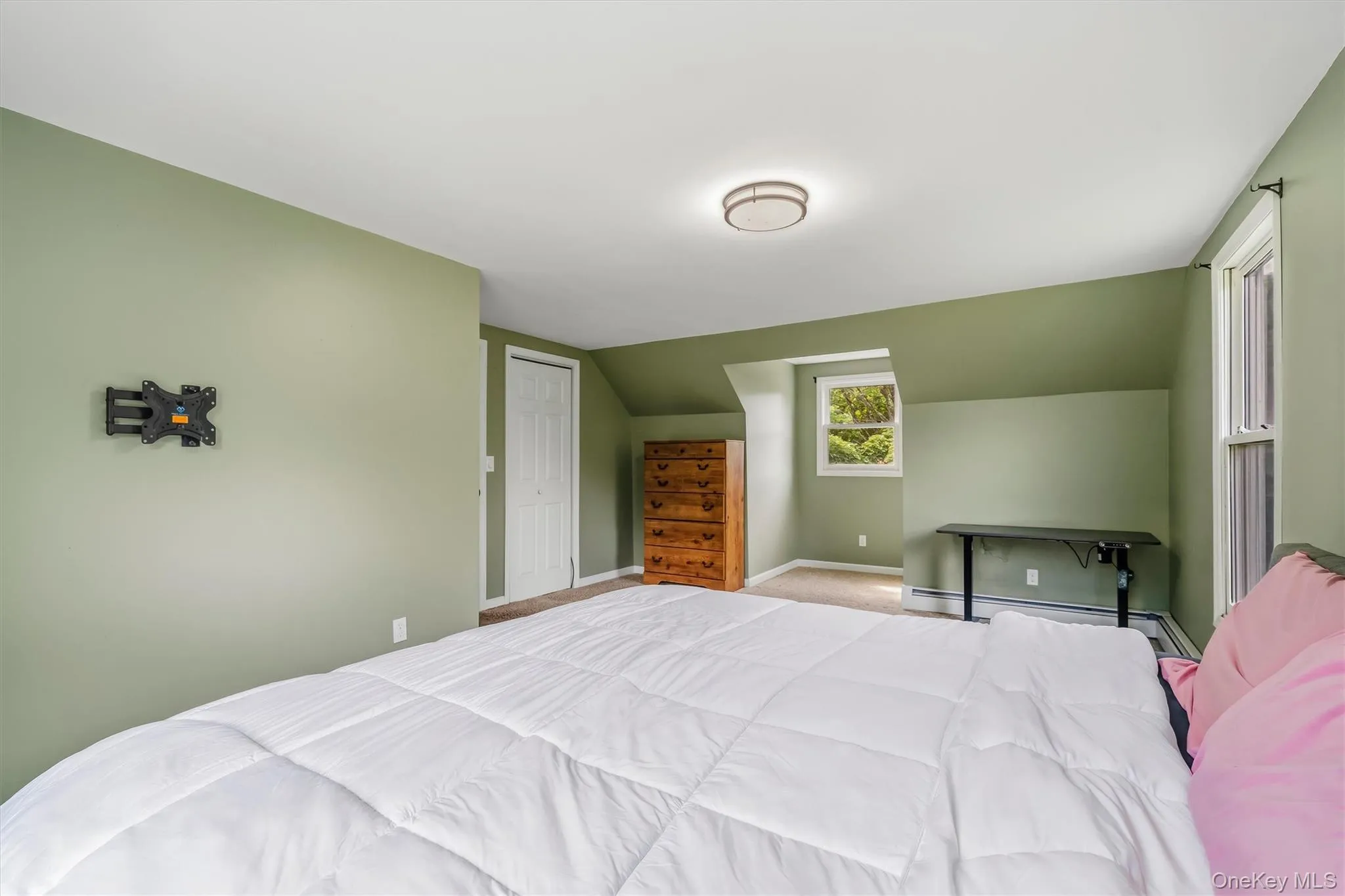 Spacious bedroom with carpeted flooring, ample closet space, and multiple windows for natural light. Spacious bedroom with carpeted flooring, ample closet space, and multiple windows for natural light.