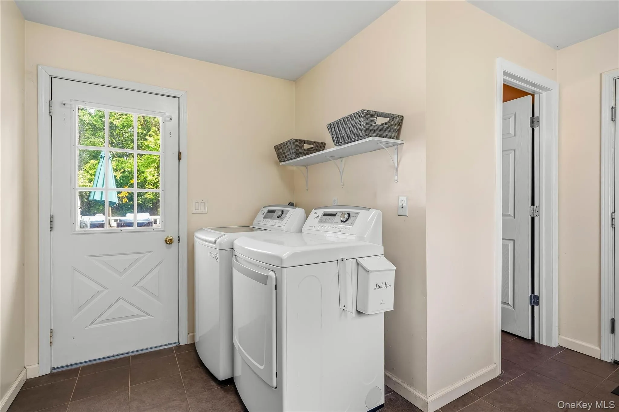 Main-level laundry area with exterior access and additional storage space. Main-level laundry area with exterior access and additional storage space.