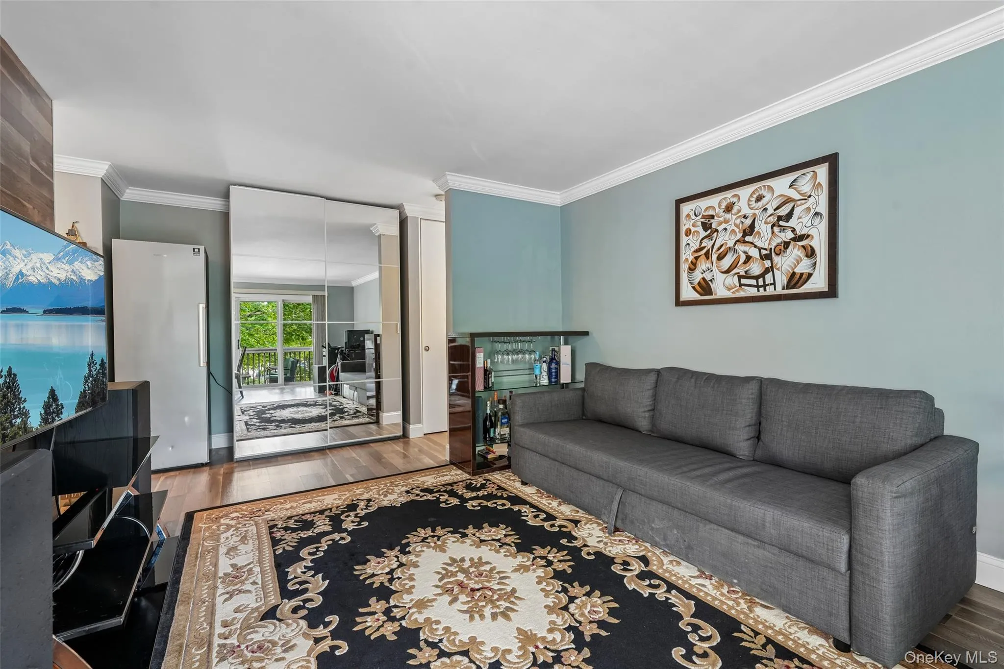 Wood-finish flooring with crown molding and light-colored walls Wood-finish flooring with crown molding and light-colored walls