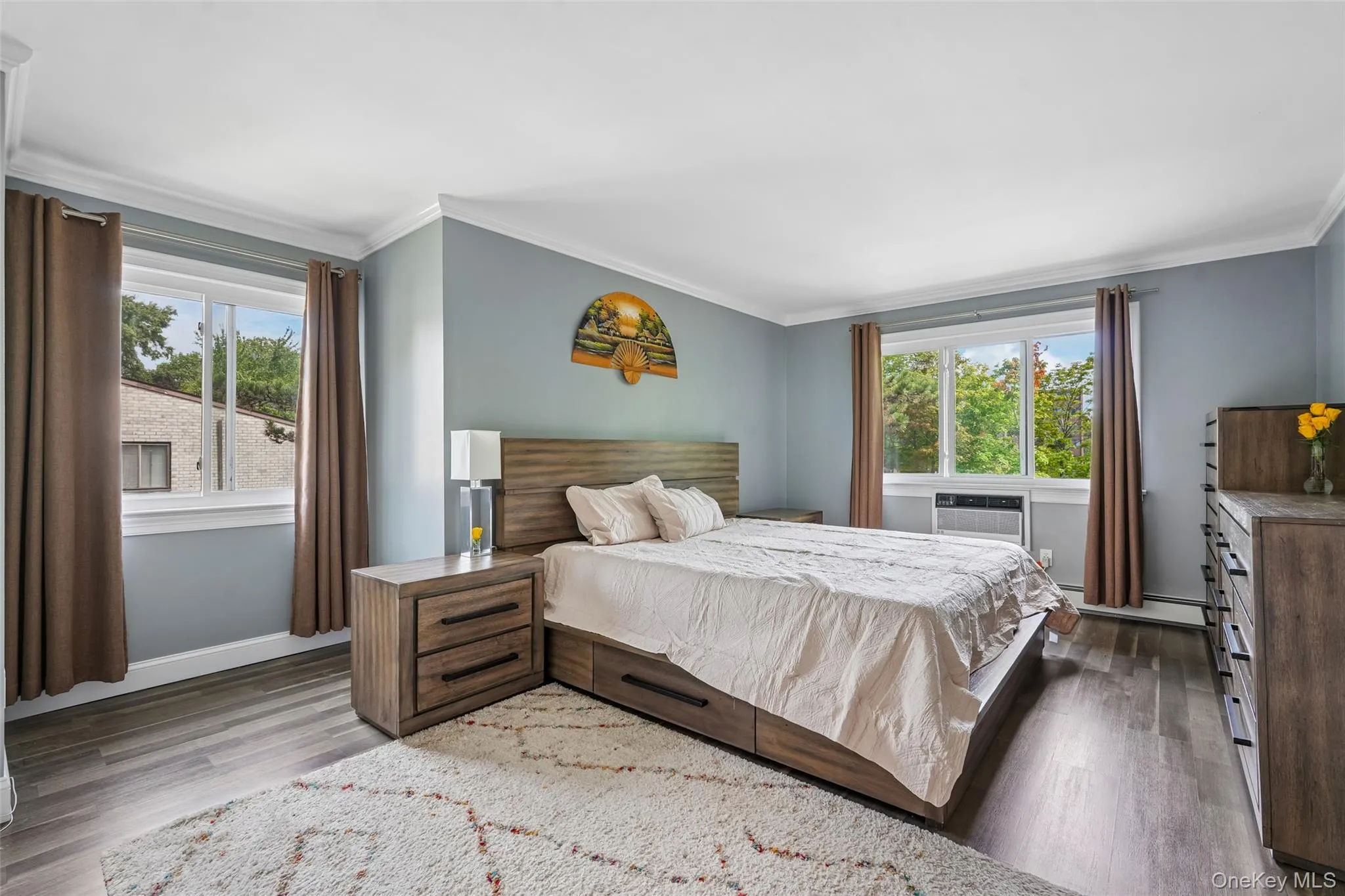 Crown molding details, wood-finish flooring, and multiple windows Crown molding details, wood-finish flooring, and multiple windows