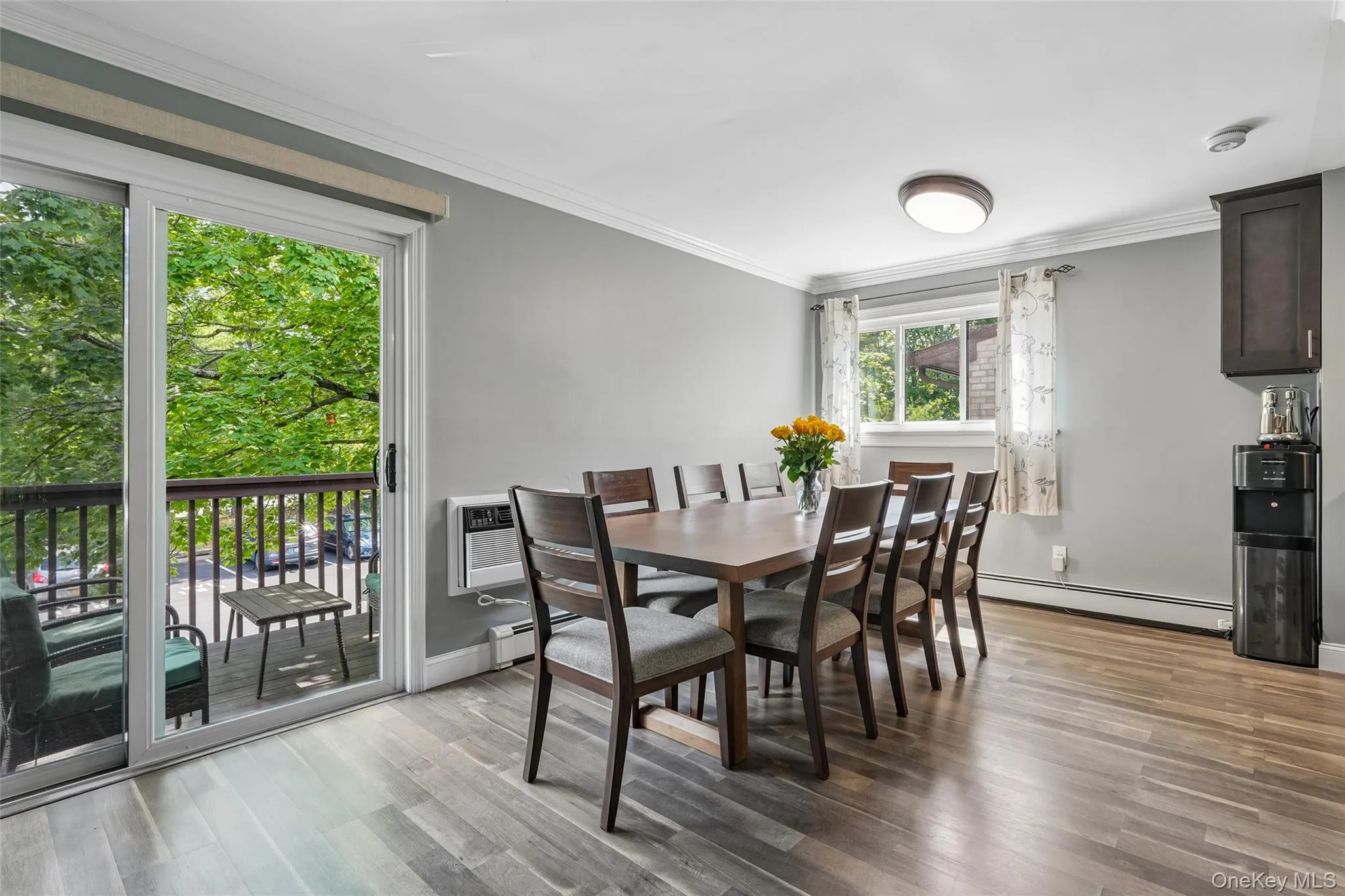 Wood-finish flooring, crown molding, and light gray wall color Wood-finish flooring, crown molding, and light gray wall color