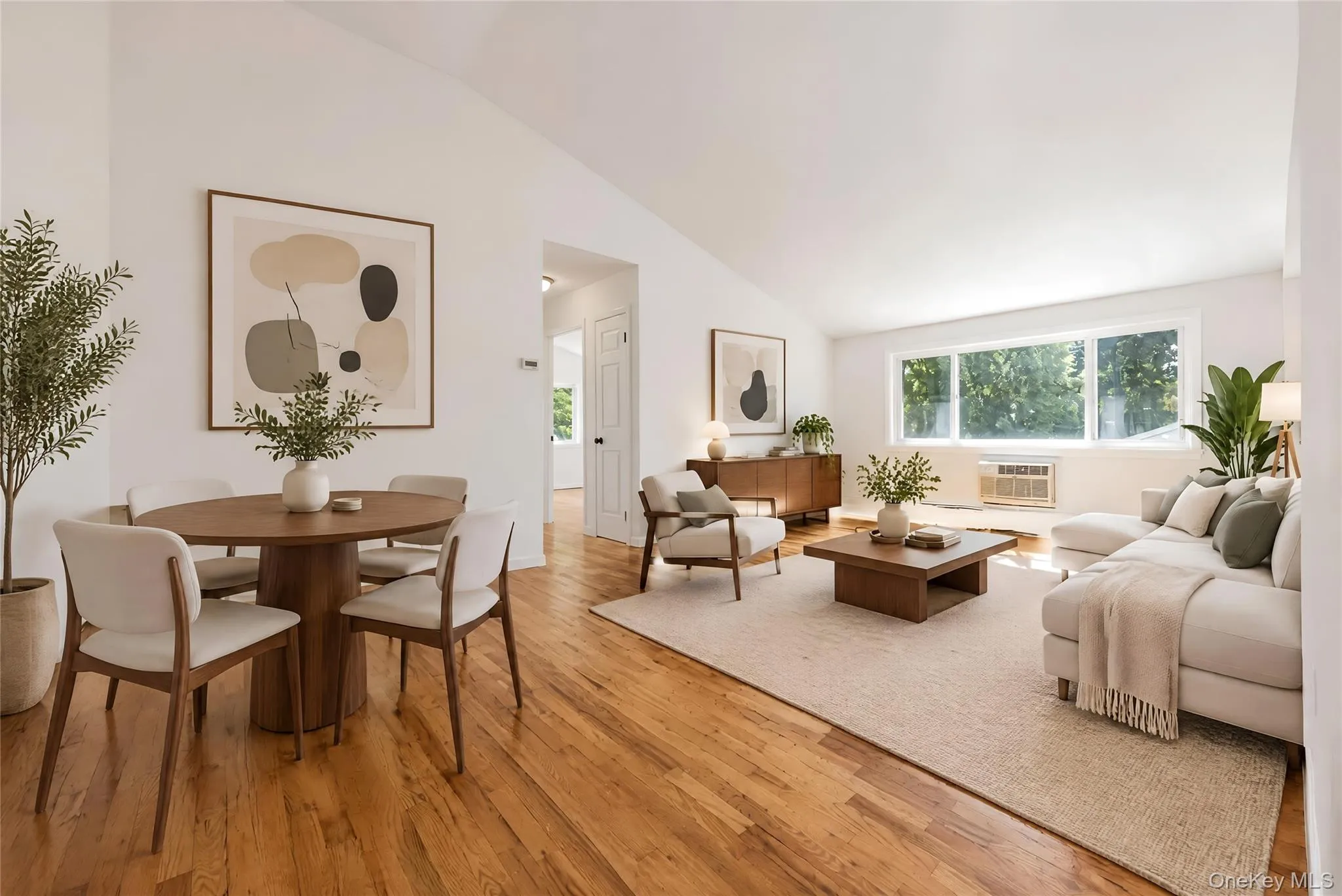 A second virtually staged perspective highlights the living room’s generous proportions, natural light and beautiful hardwood floors. A second virtually staged perspective highlights the living room’s generous proportions, natural light and beautiful hardwood floors.