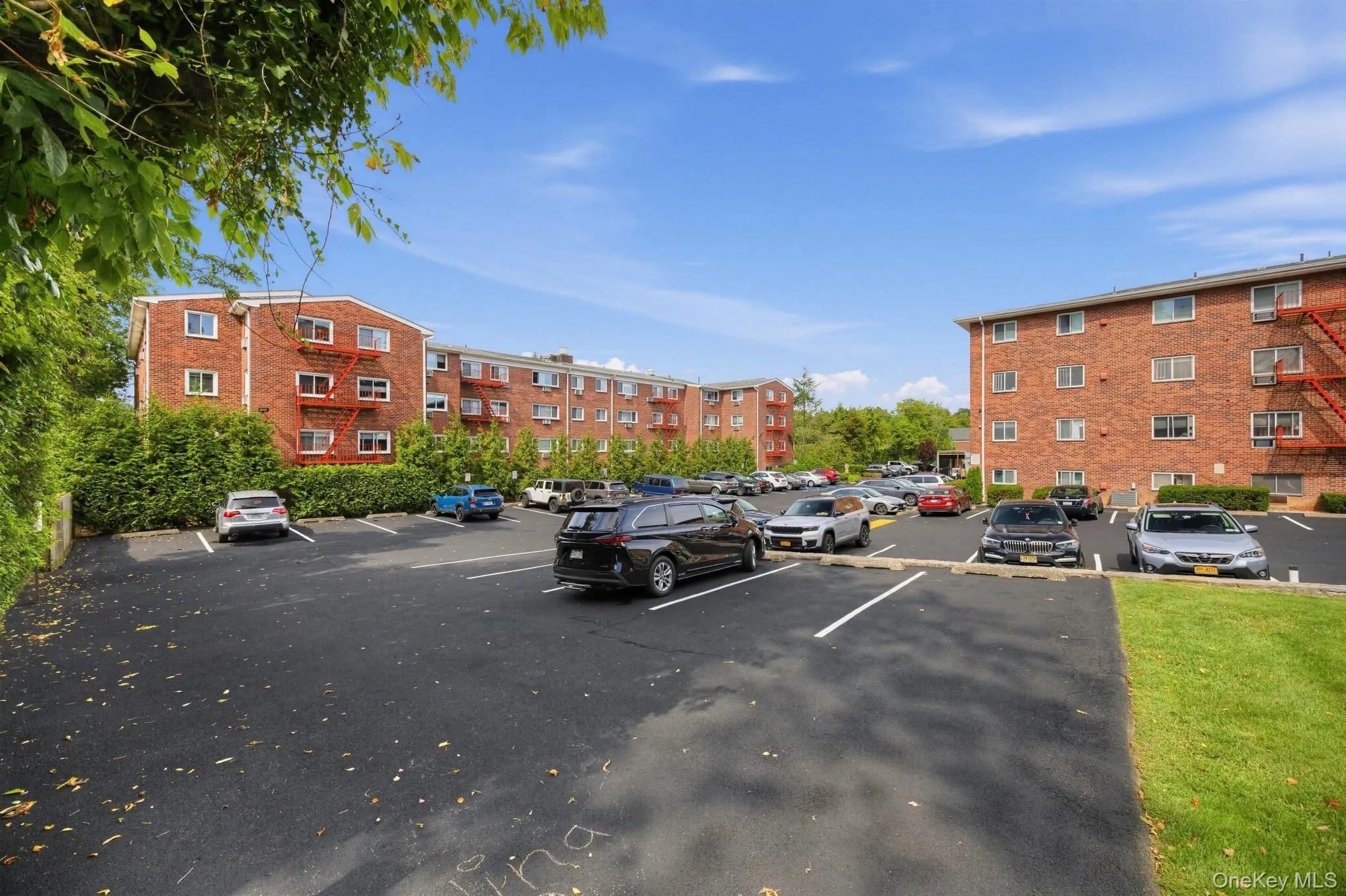 See 4L’s desirable top-floor corner location at the upper left of the building, overlooking the rear grounds and parking area. One unassigned parking space is included. See 4L’s desirable top-floor corner location at the upper left of the building, overlooking the rear grounds and parking area. One unassigned parking space is included.