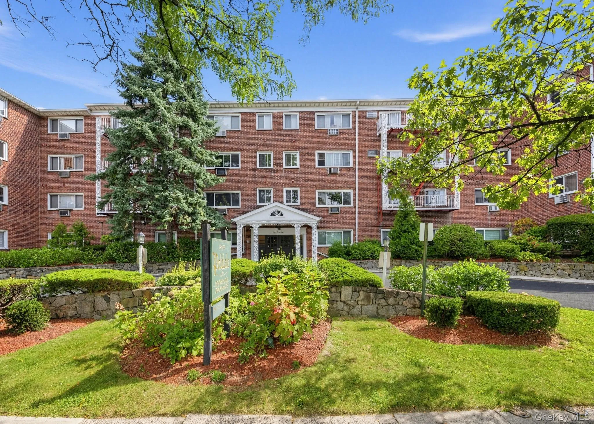 The welcoming entrance to 828 Pelhamdale Avenue, framed by mature landscaping and distinctive architectural details. The welcoming entrance to 828 Pelhamdale Avenue, framed by mature landscaping and distinctive architectural details.